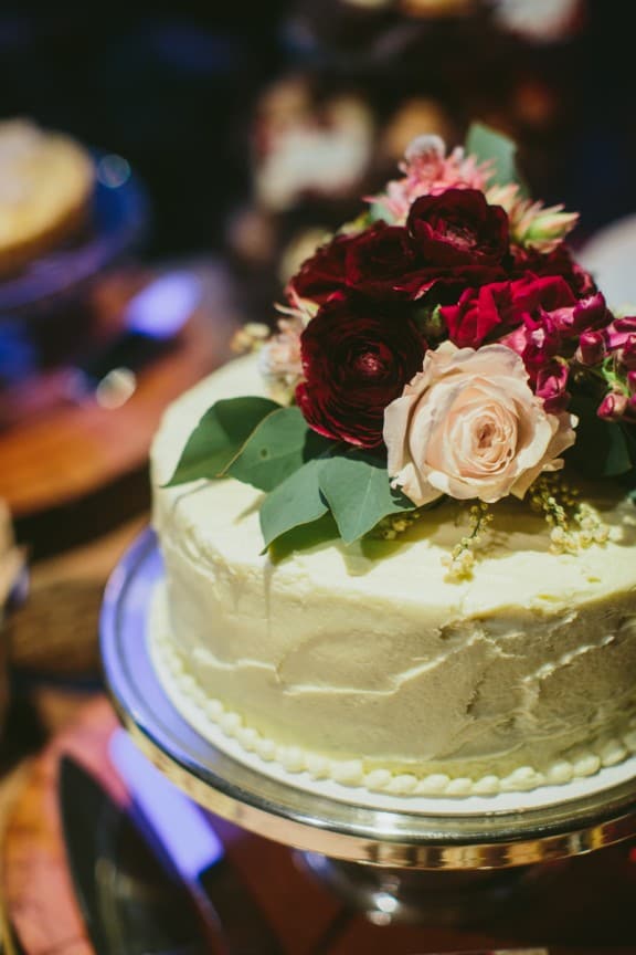 Simple wedding cake topped with fresh flowers | Still Love Photography