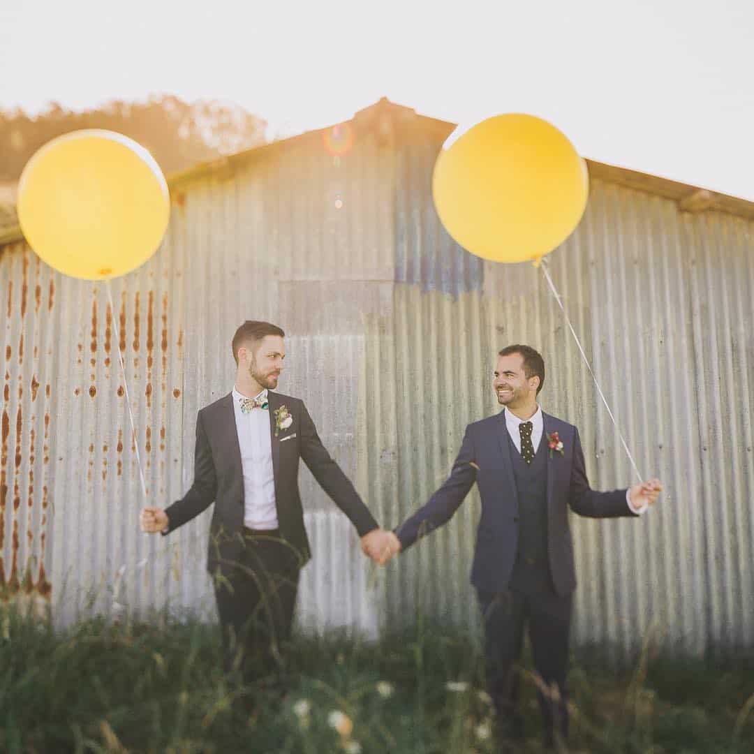 two grooms with balloons