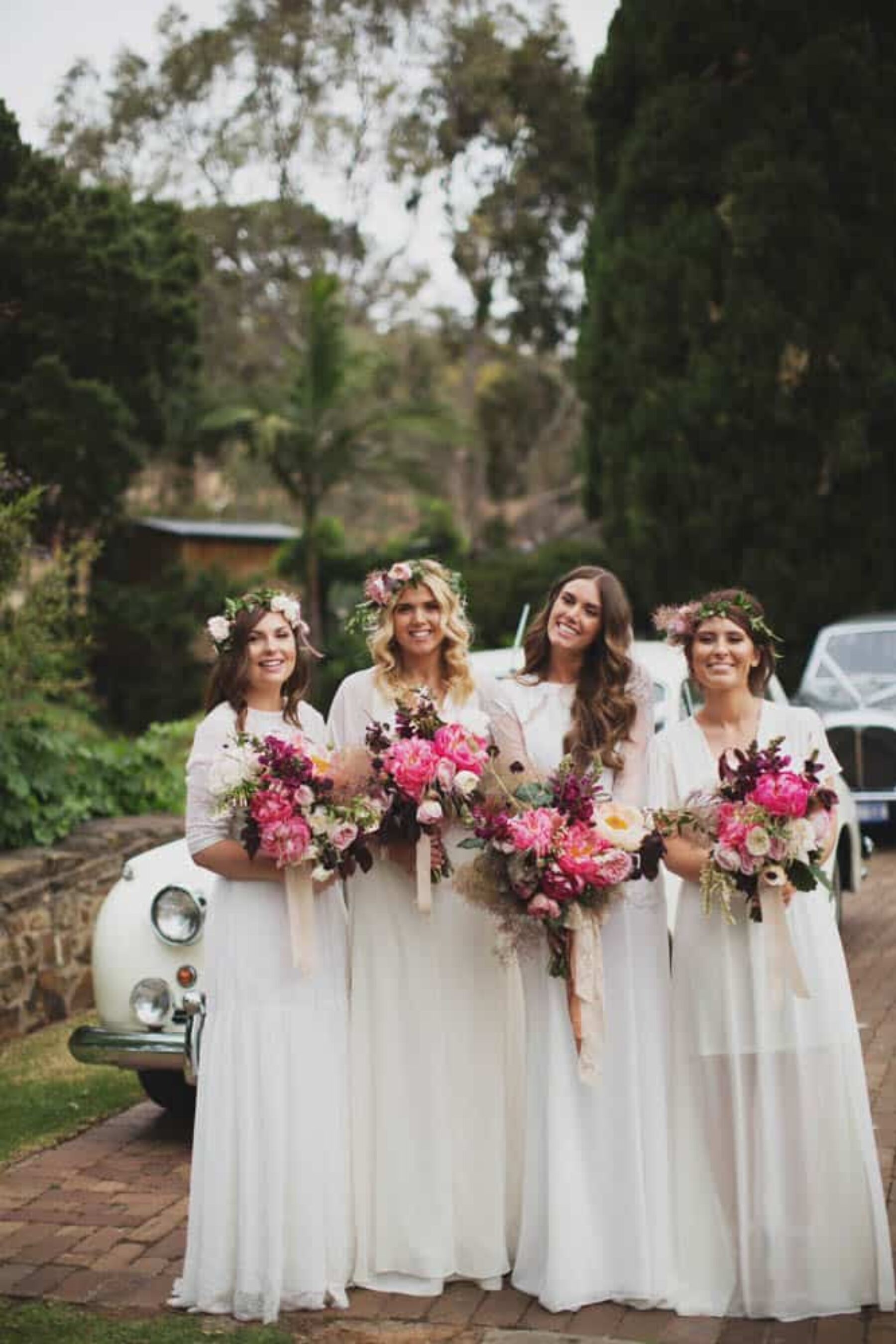 Bride and bridesmaids with vibrant peony bouquets