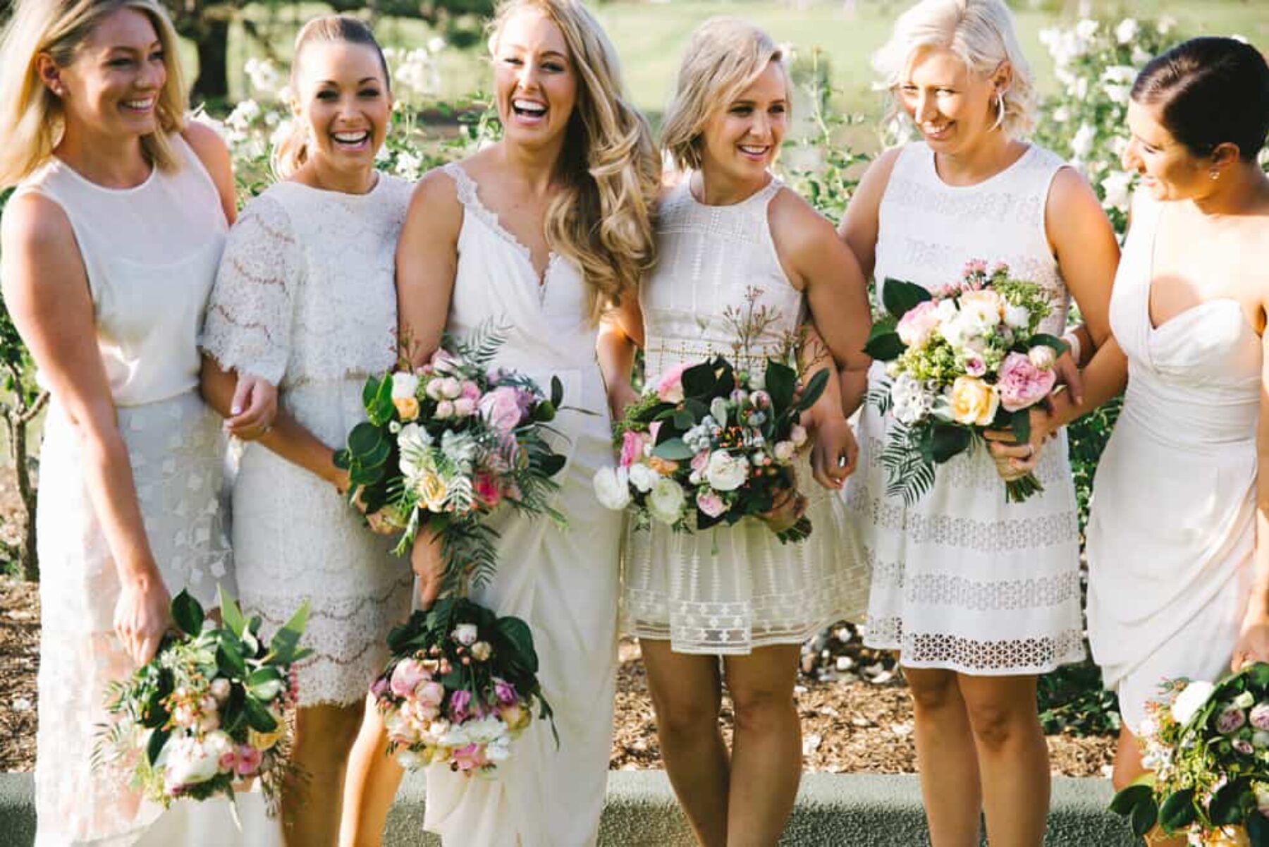 Bridesmaids in different white dresses / Kait Photography