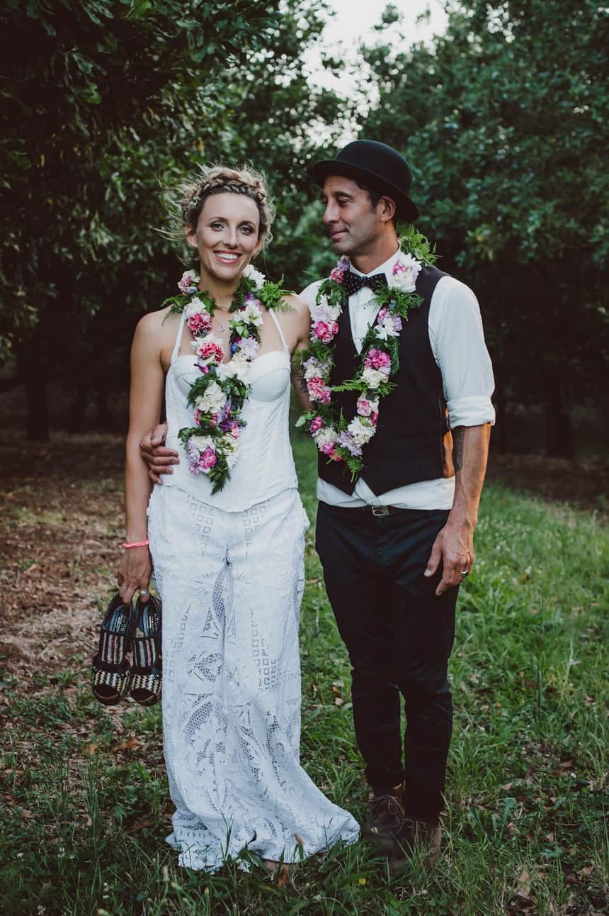 boho bride and groom wearing floral leis necklaces