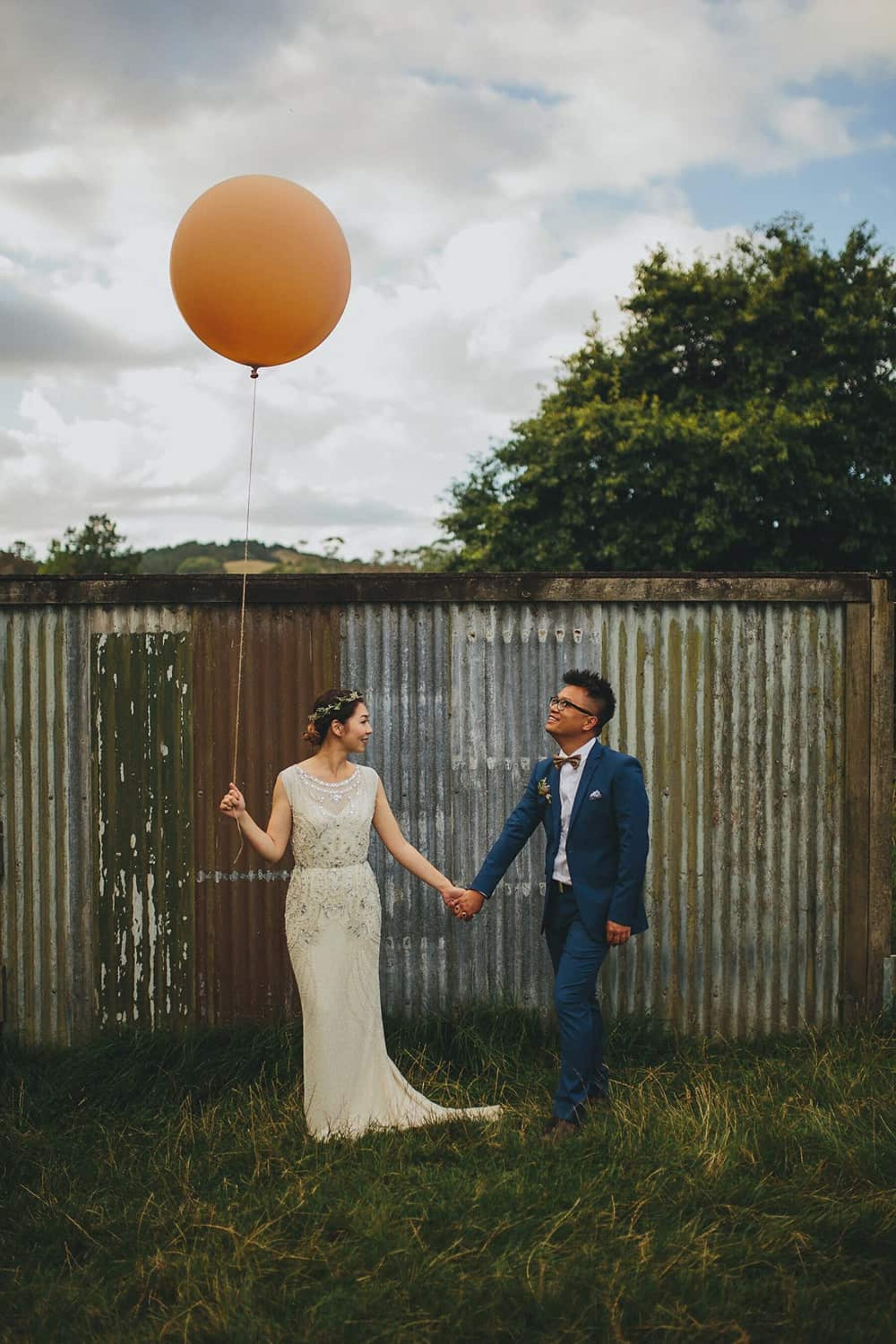 bride and groom with giant balloon