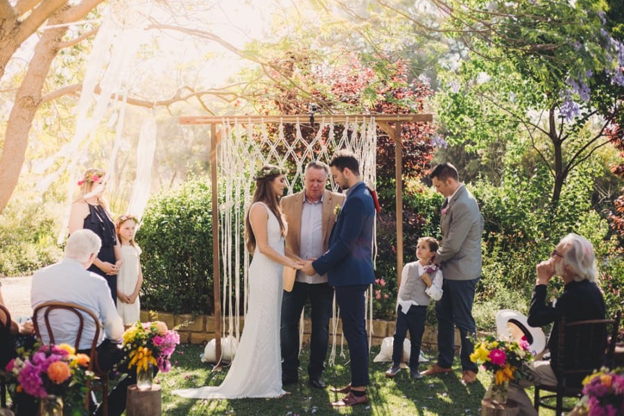 boho backyard wedding with macrame backdrop
