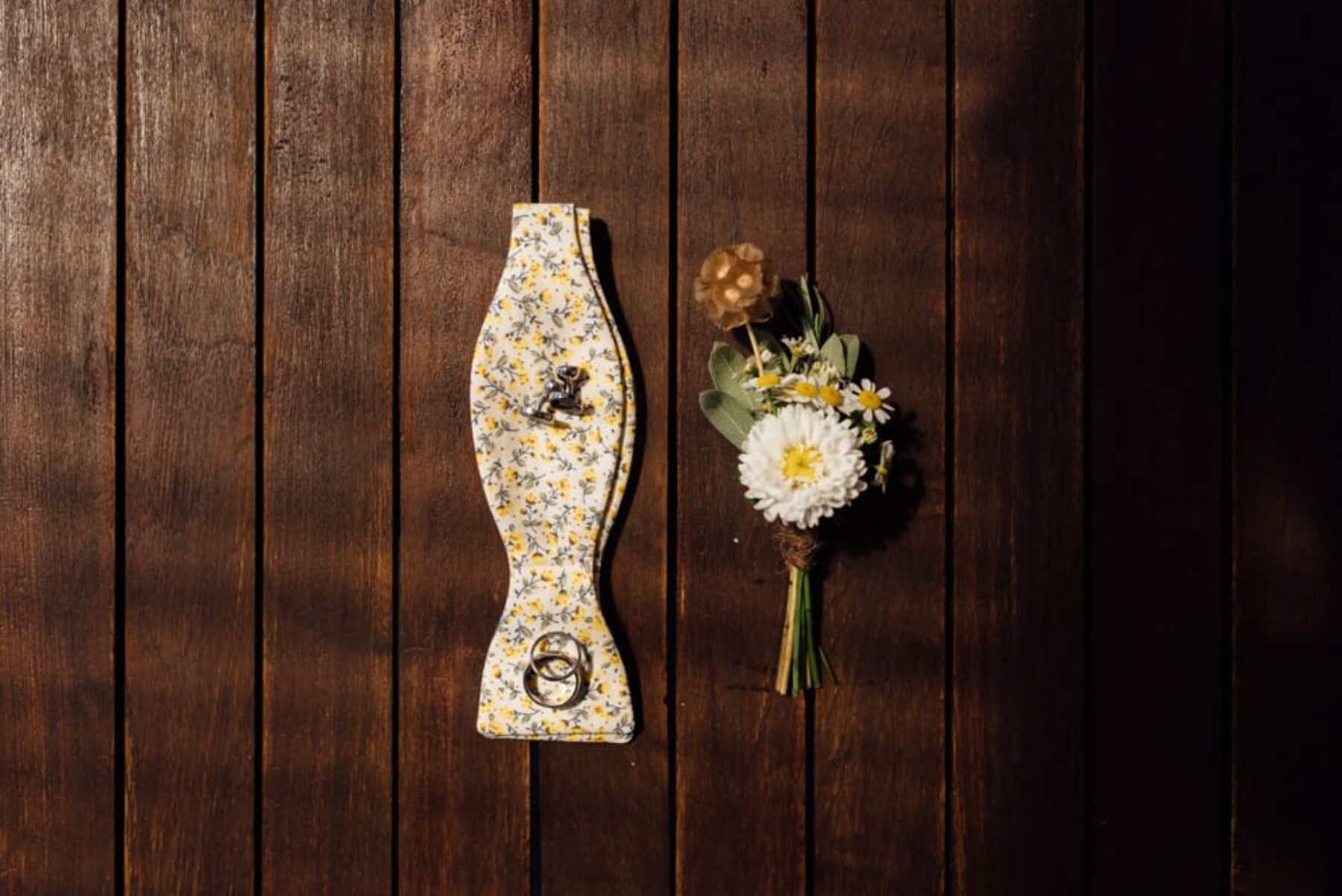 daisy boutonniere and yellow floral bow tie