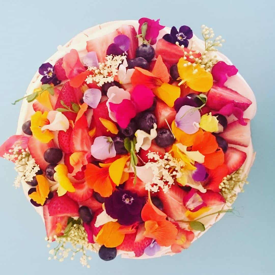 creative cake with edible flowers by by Unbirthday Bakery Sydney