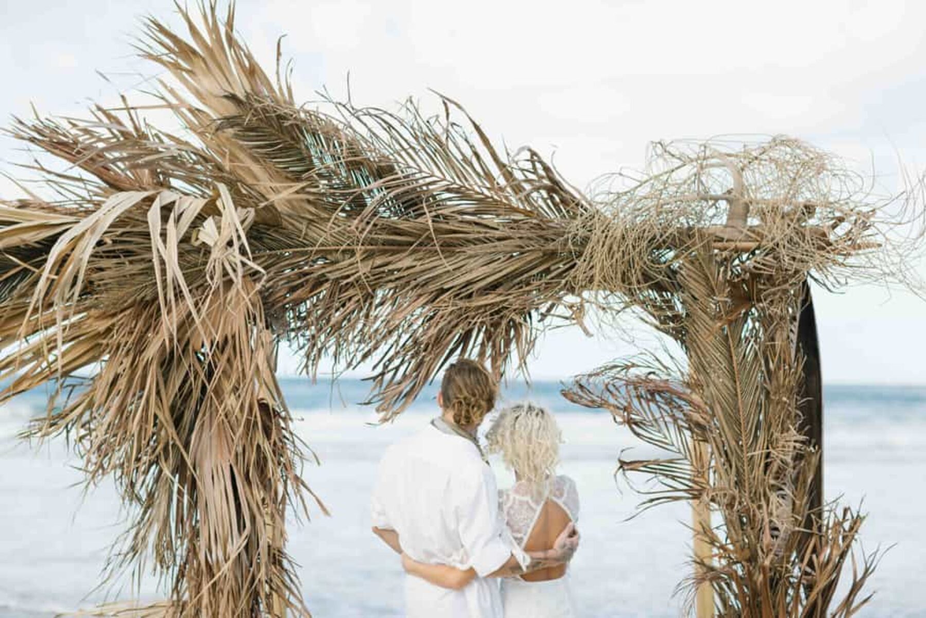 beach wedding arbour of dried palm fronds