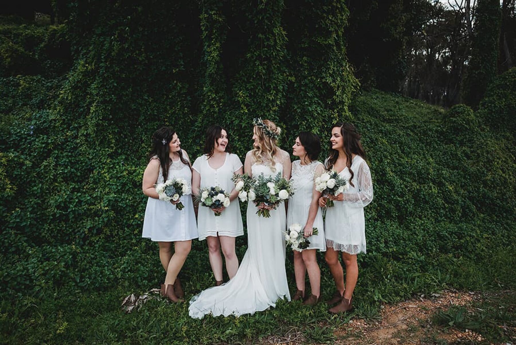 bridesmaids in mismatching white dresses