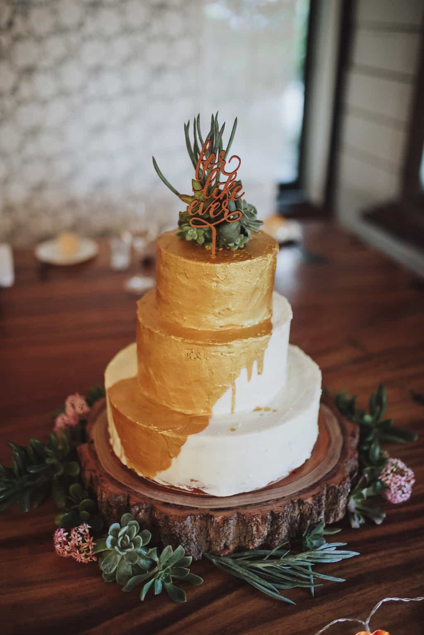 gold wedding cake with succulents