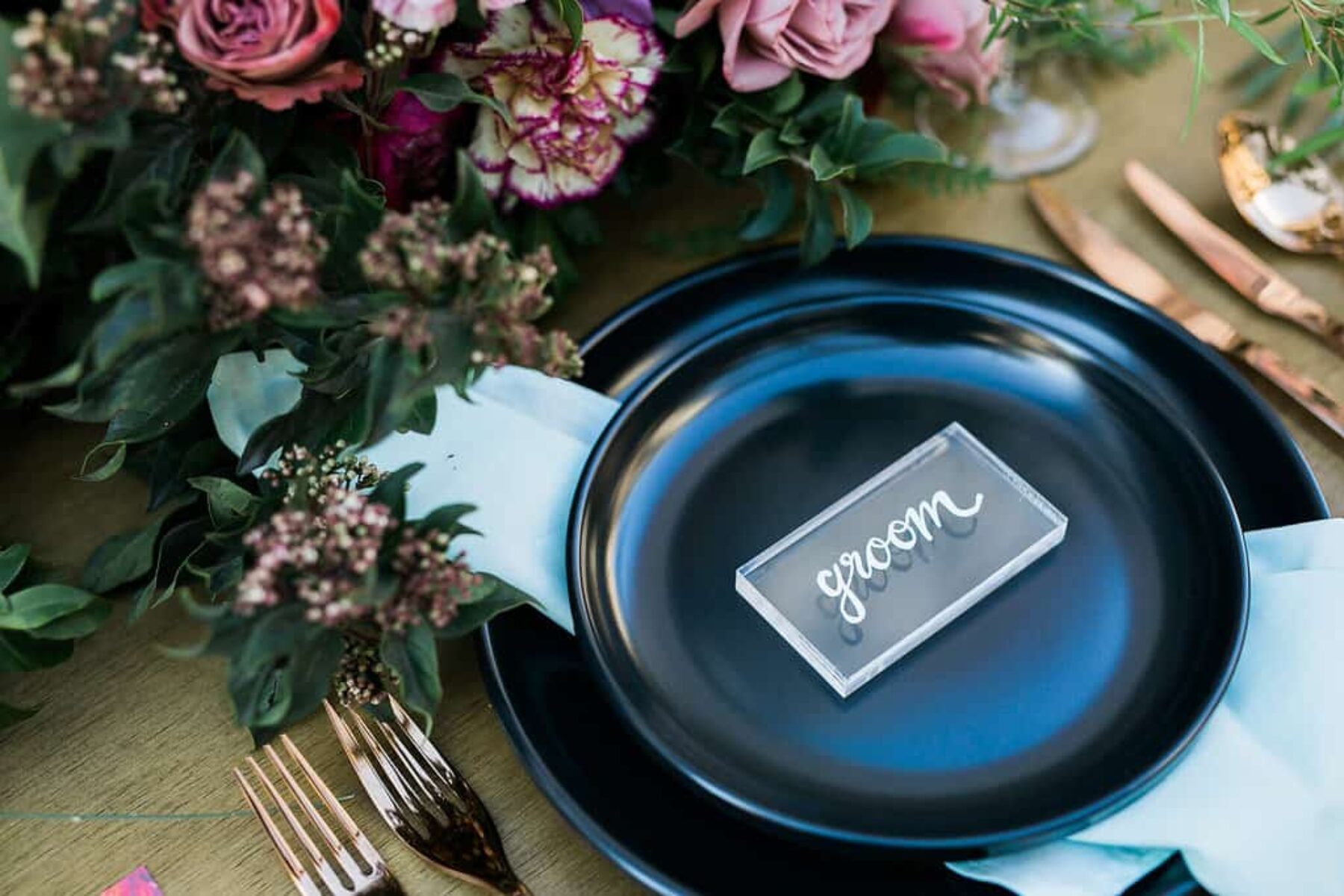 black crockery with perspex place setting