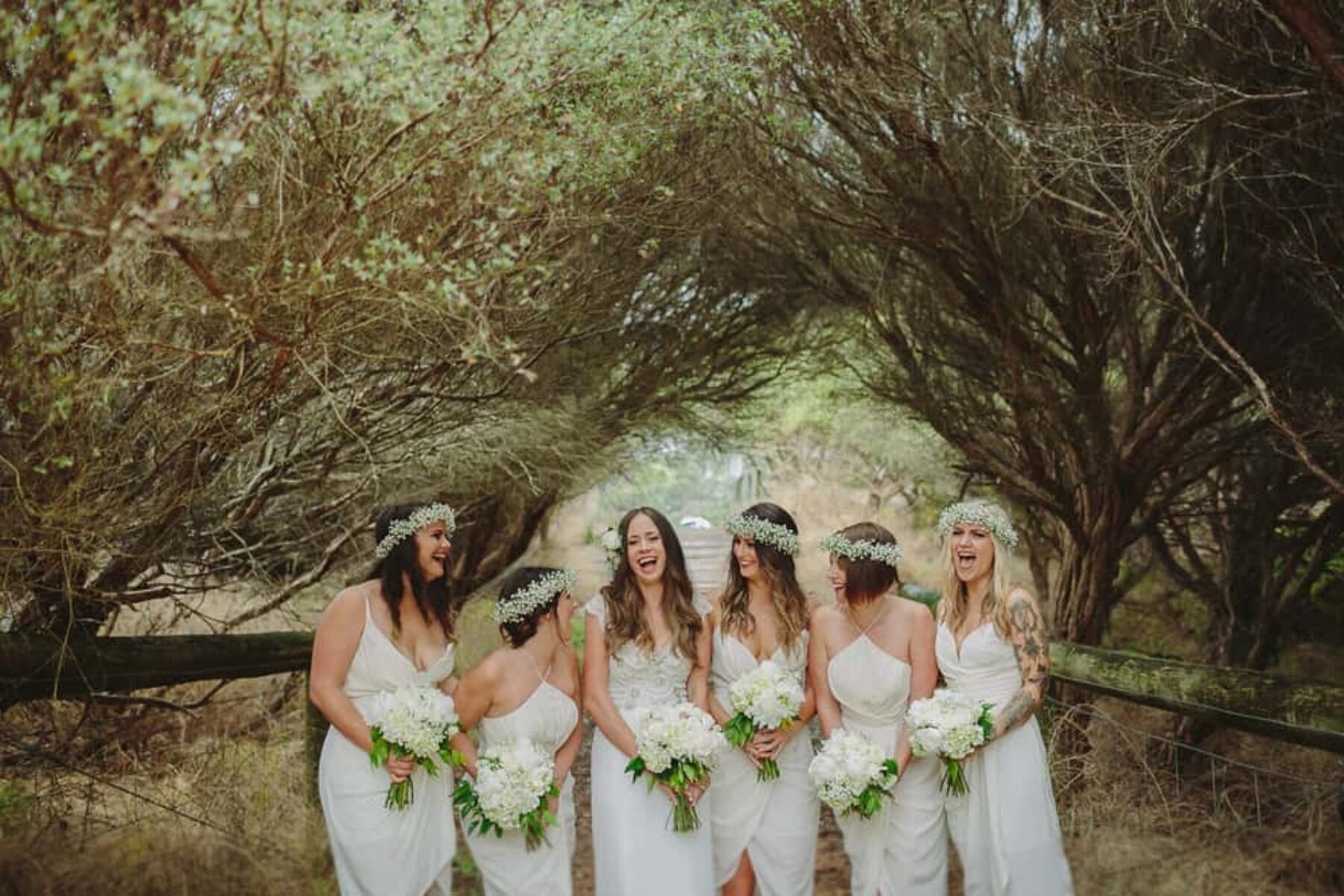 bridesmaids in white Zimmermann dresses and baby's breath flower crowns