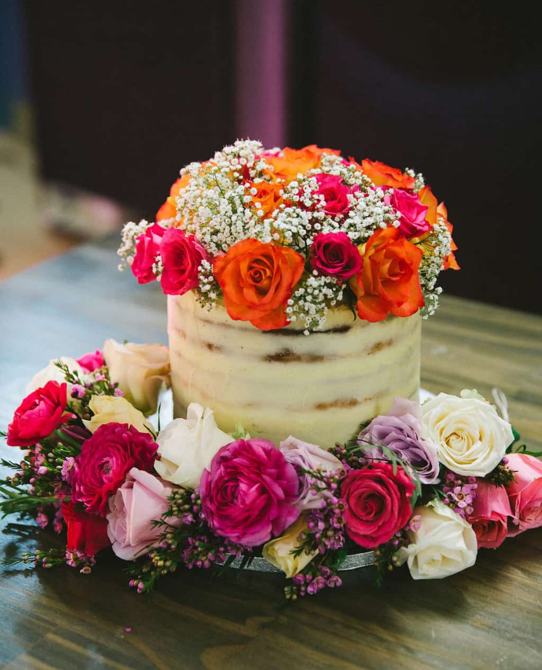 nearly-naked cake with fresh flowers