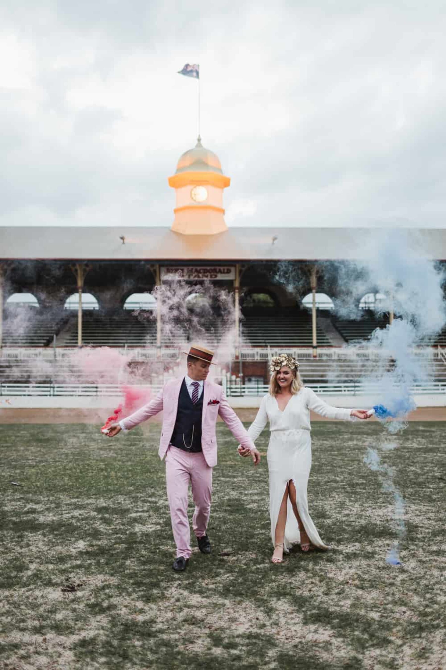 bride and groom with colour smoke bombs