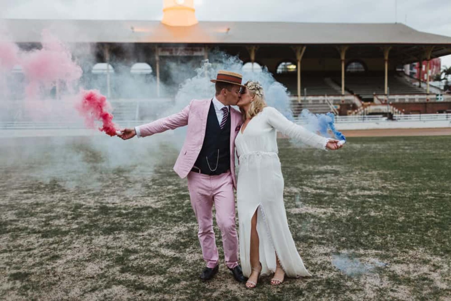 bride and groom with colour smoke bombs