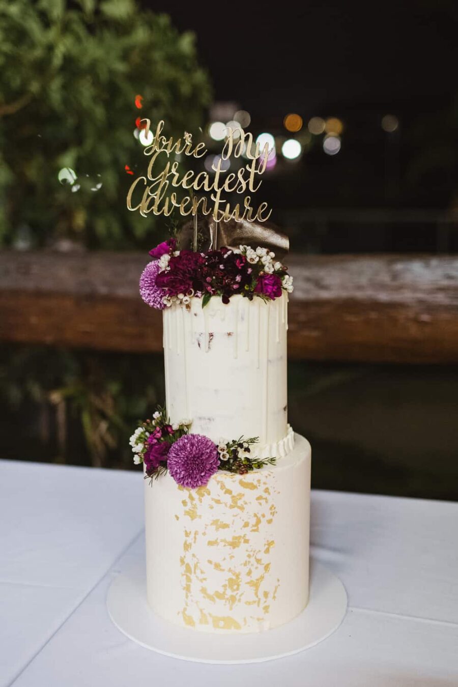 gold leaf wedding cake with typographic topper