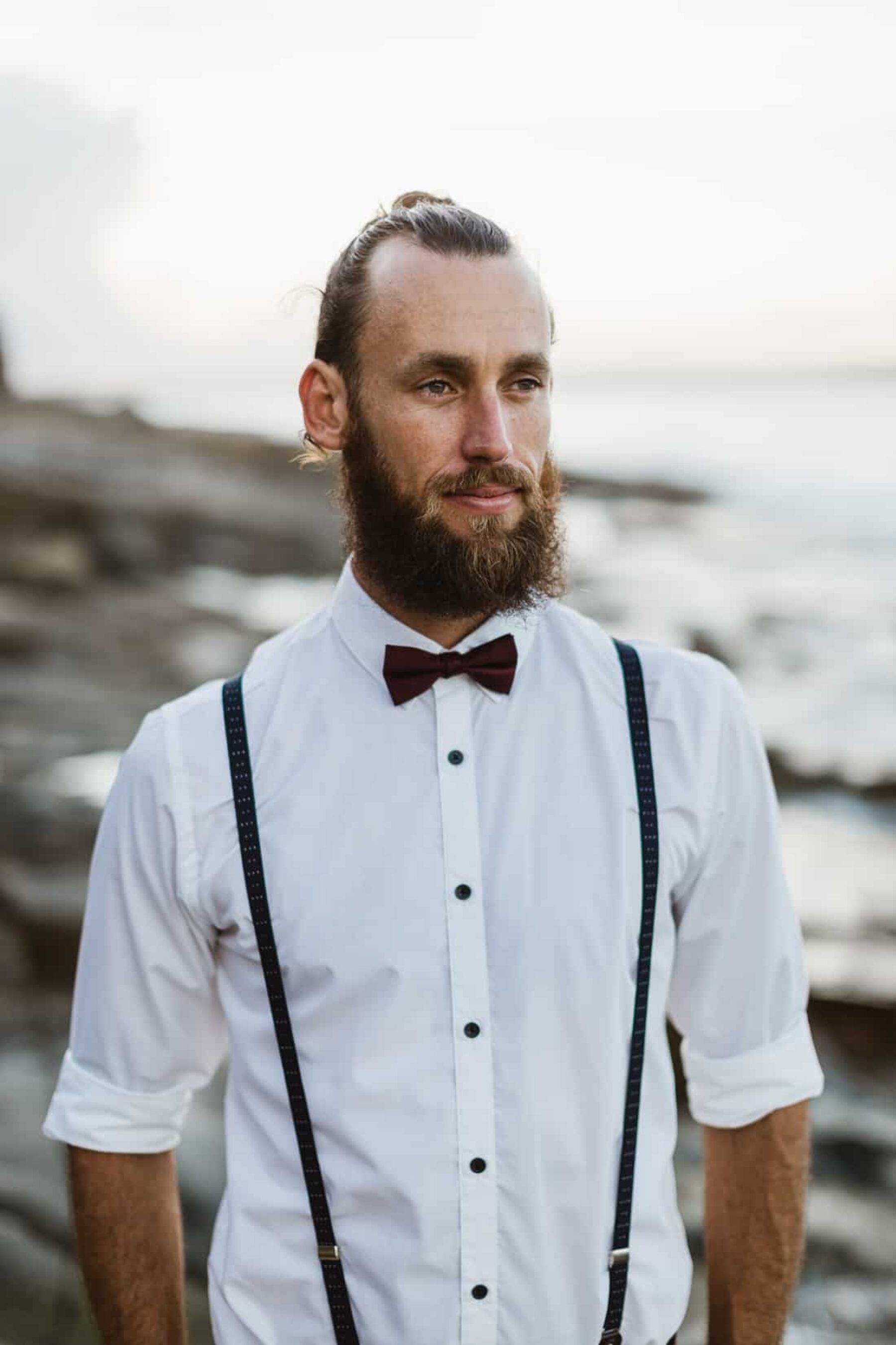 surfer groom with braces and bow tie