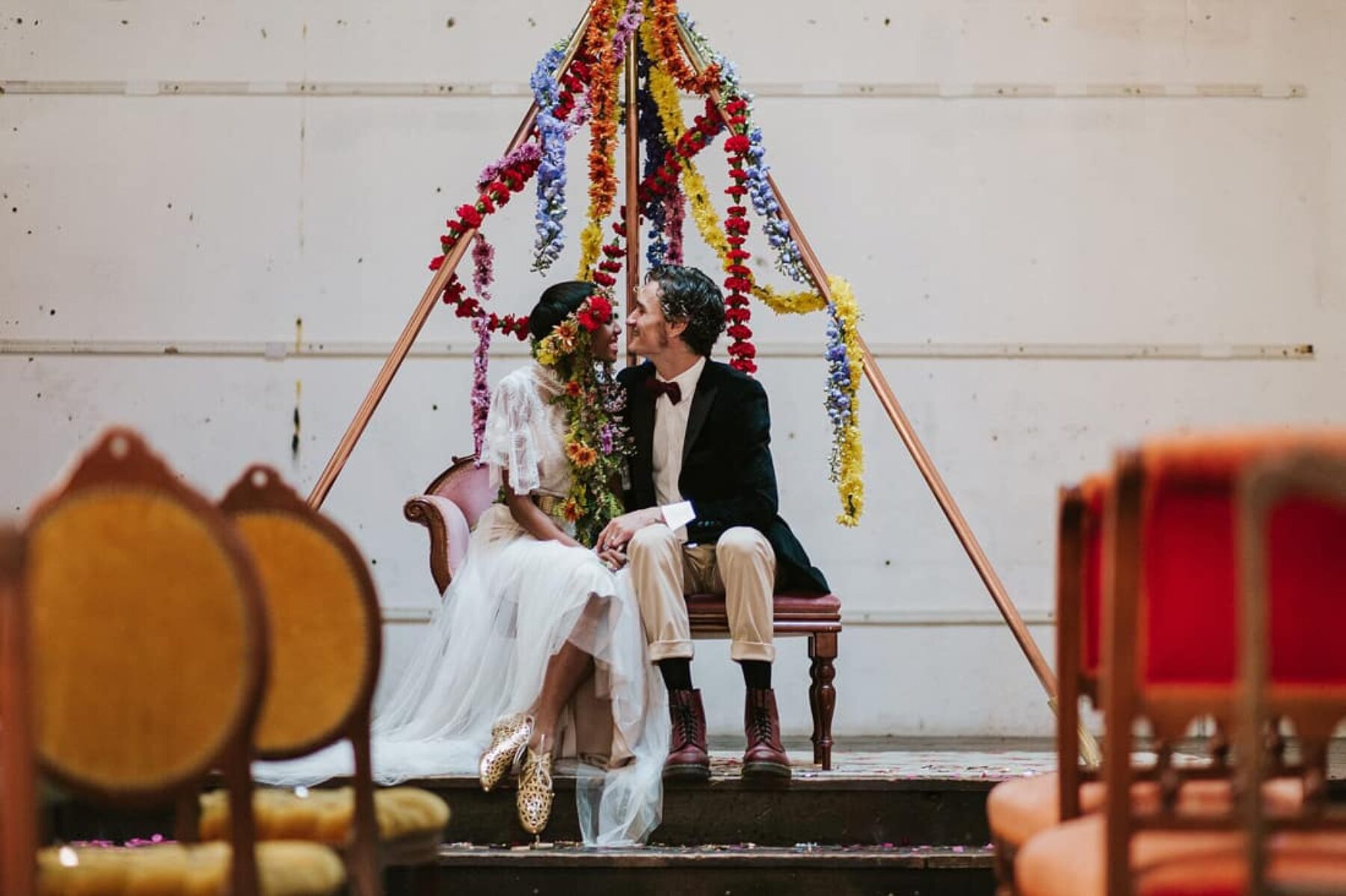 pyramid wedding backdrop with floral garlands