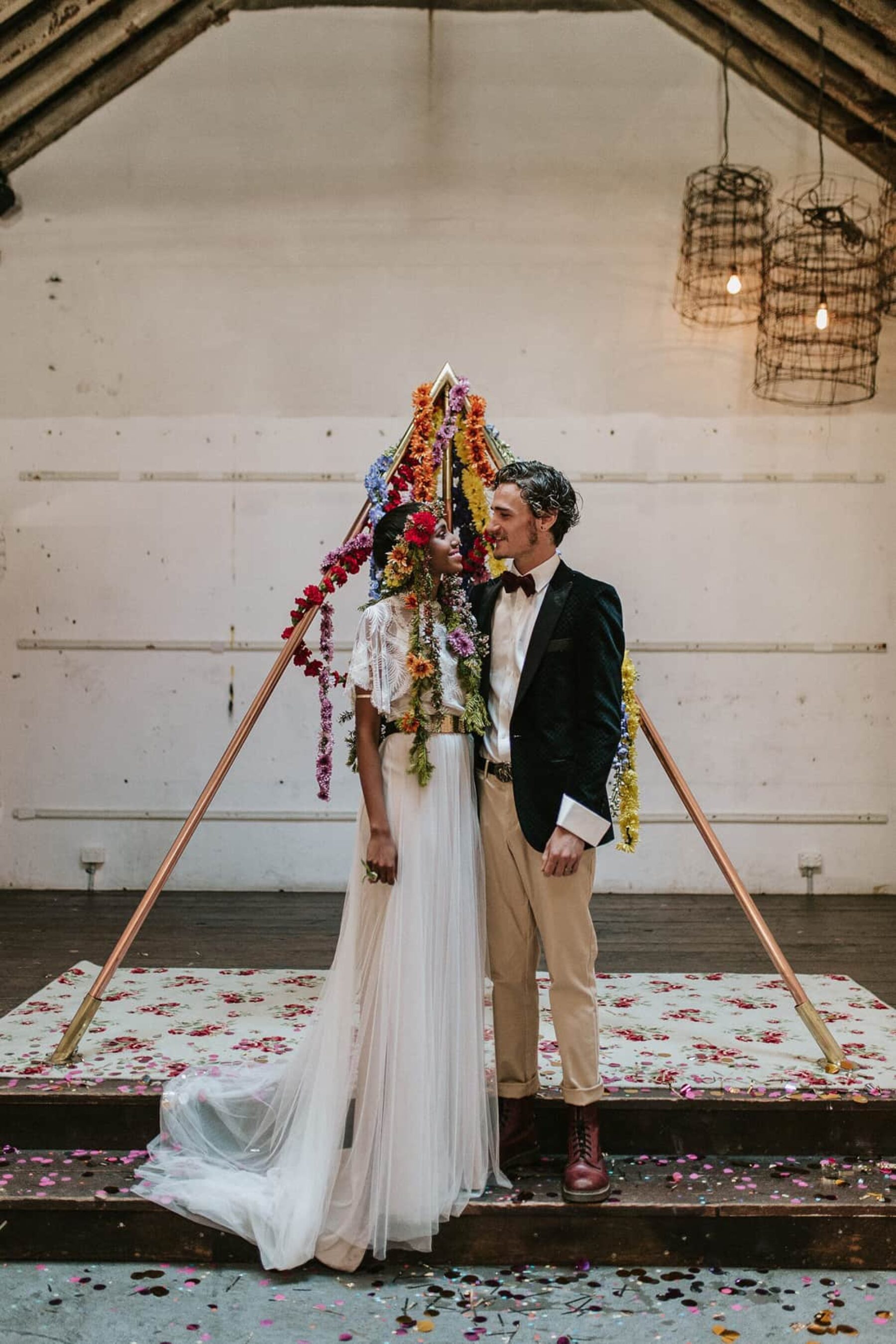 pyramid wedding backdrop with floral garlands