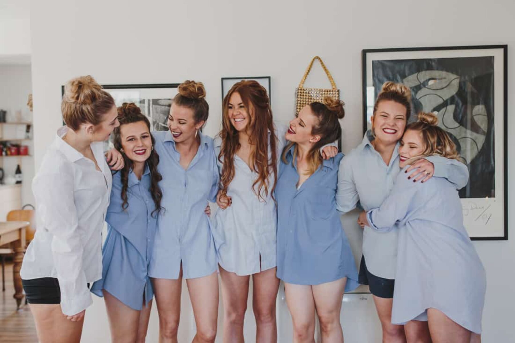 bridesmaids getting ready in mens blue shirts