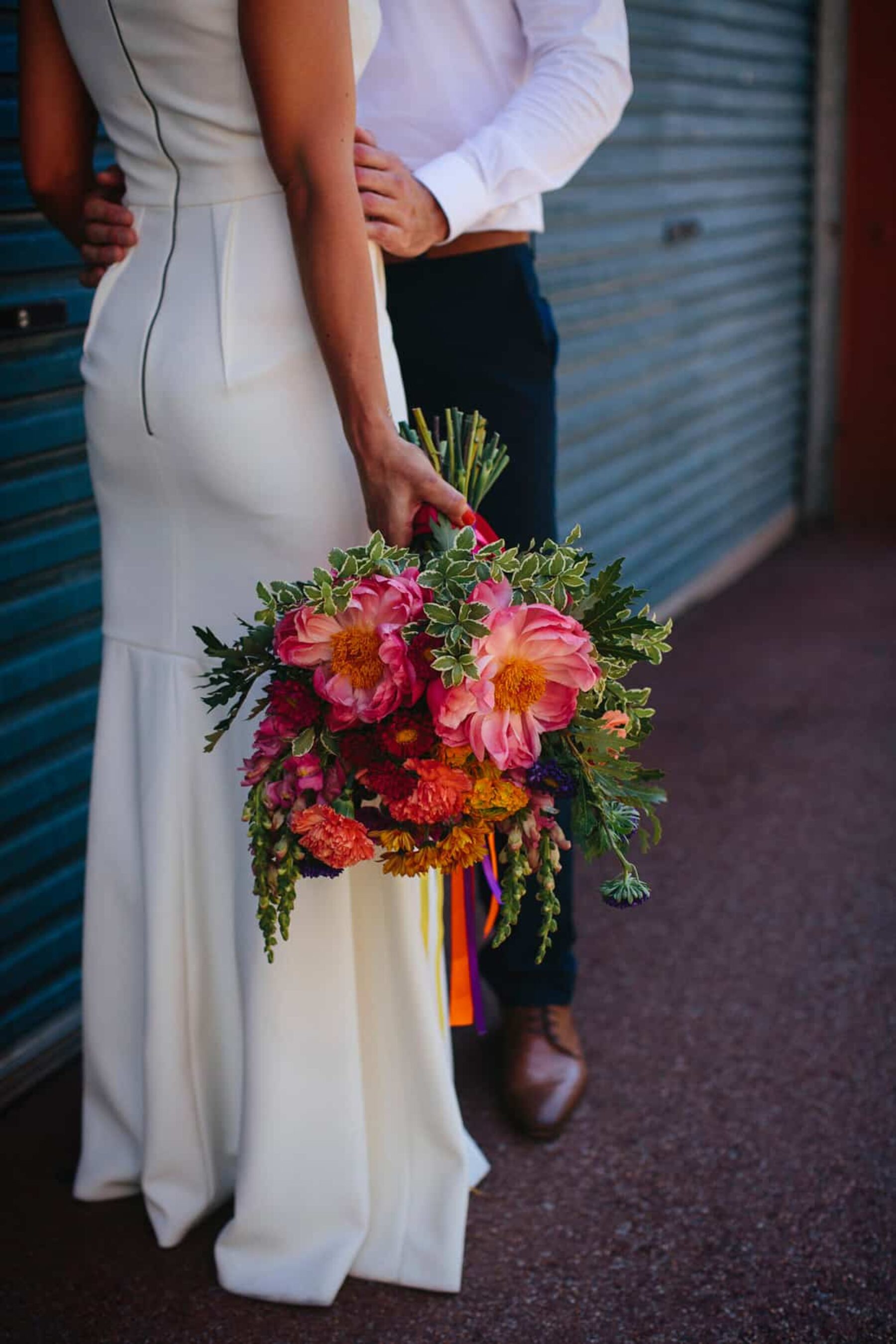 vibrant bouquet with coral peonies and colourful ribbons