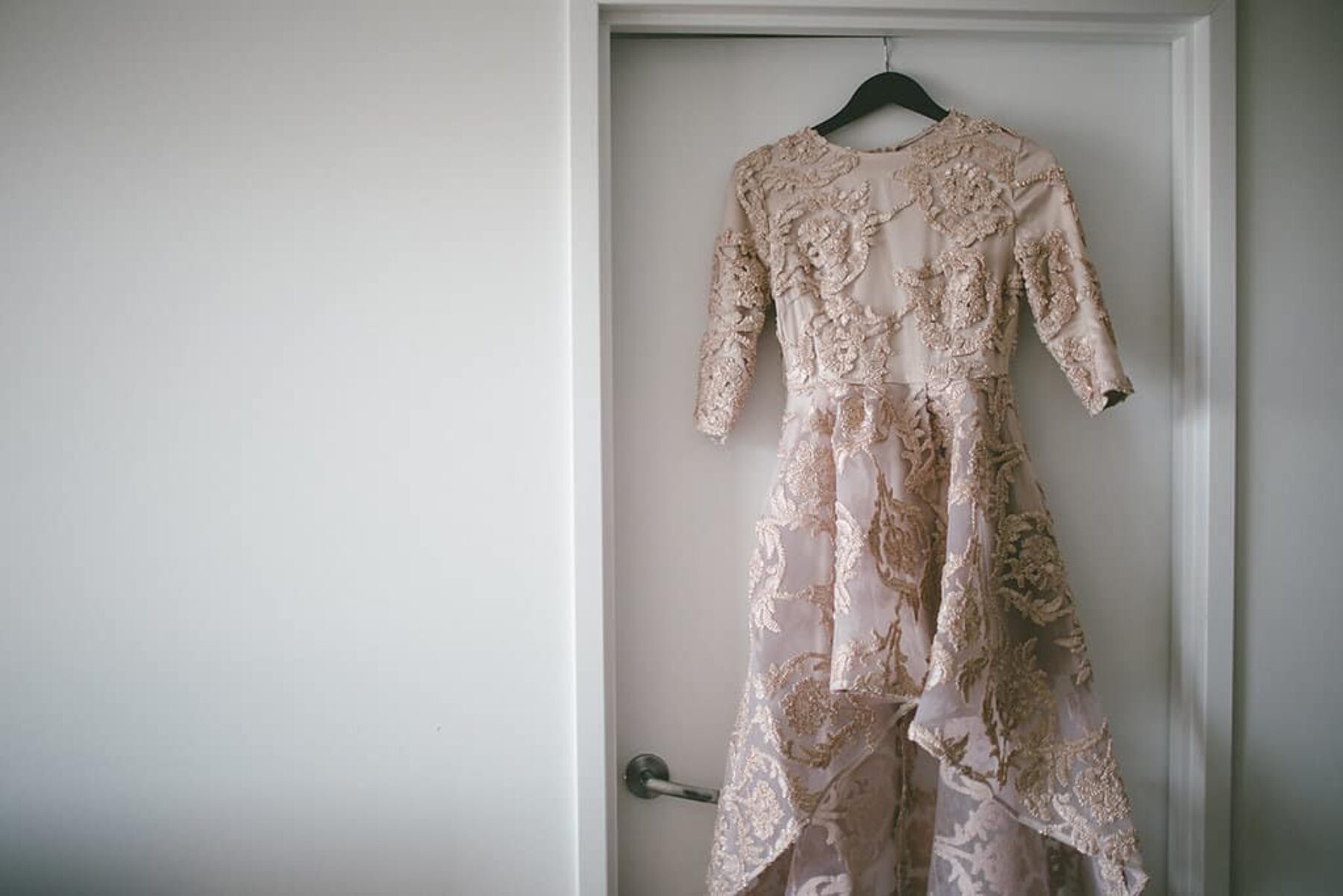blush wedding dress with asymmetrical hemline