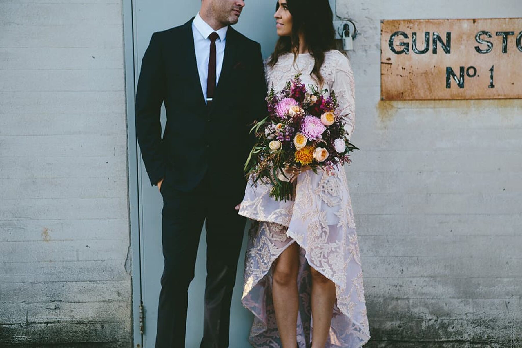 boho bride in blush wedding dress with asymmetrical hemline