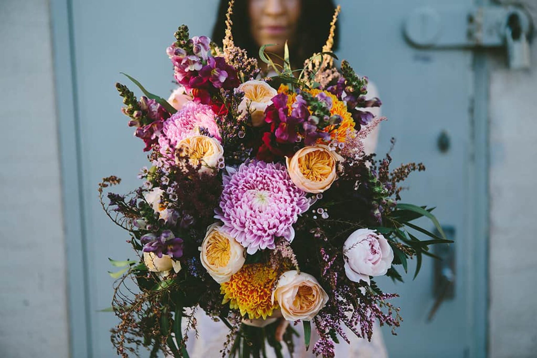 unstructured pink and peach bouquet with dahlias and peonies