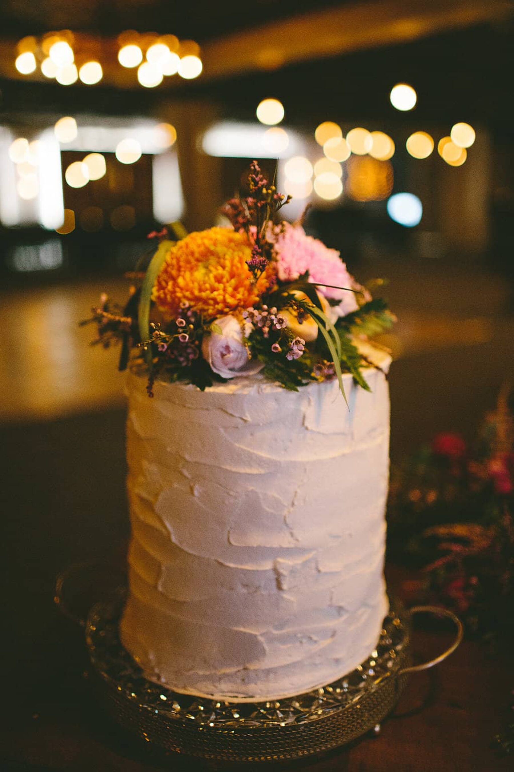single tier wedding cake with fresh flowers