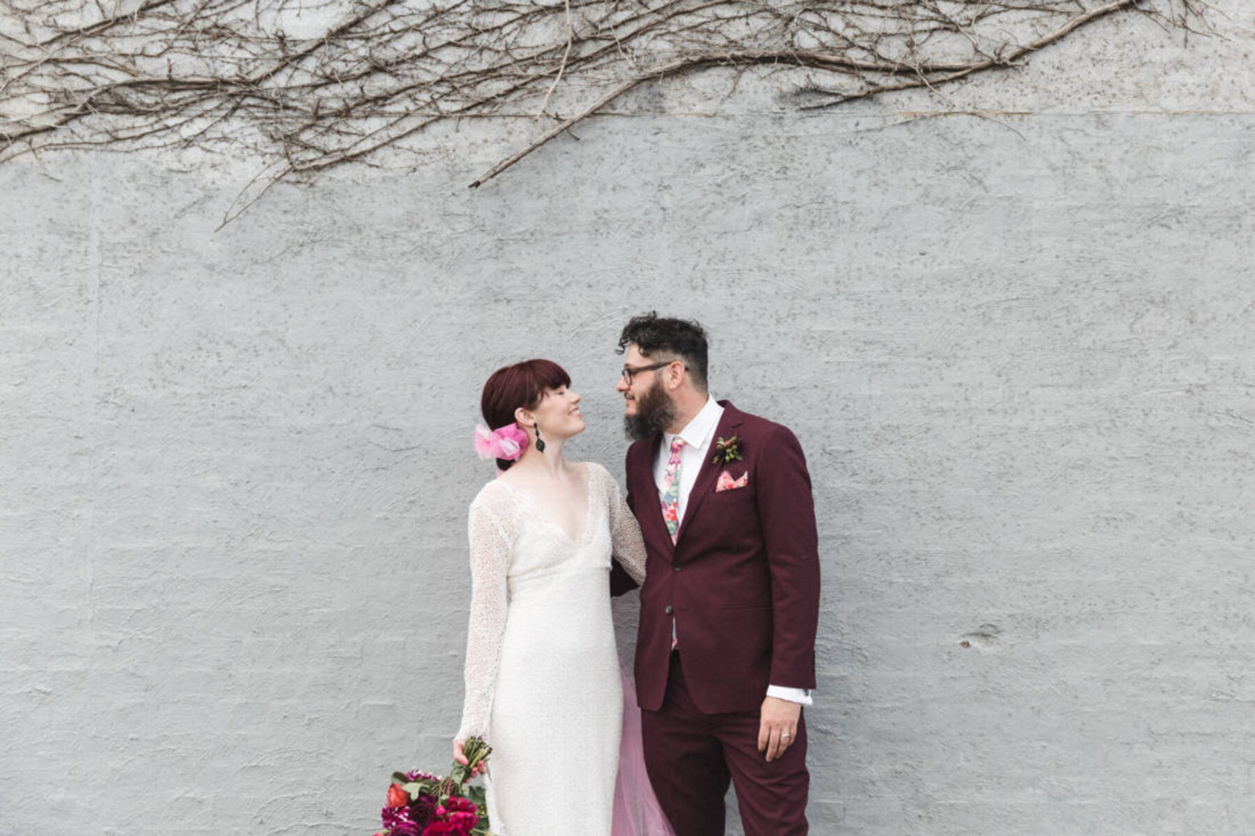 bearded groom and bride with pink tulle veil