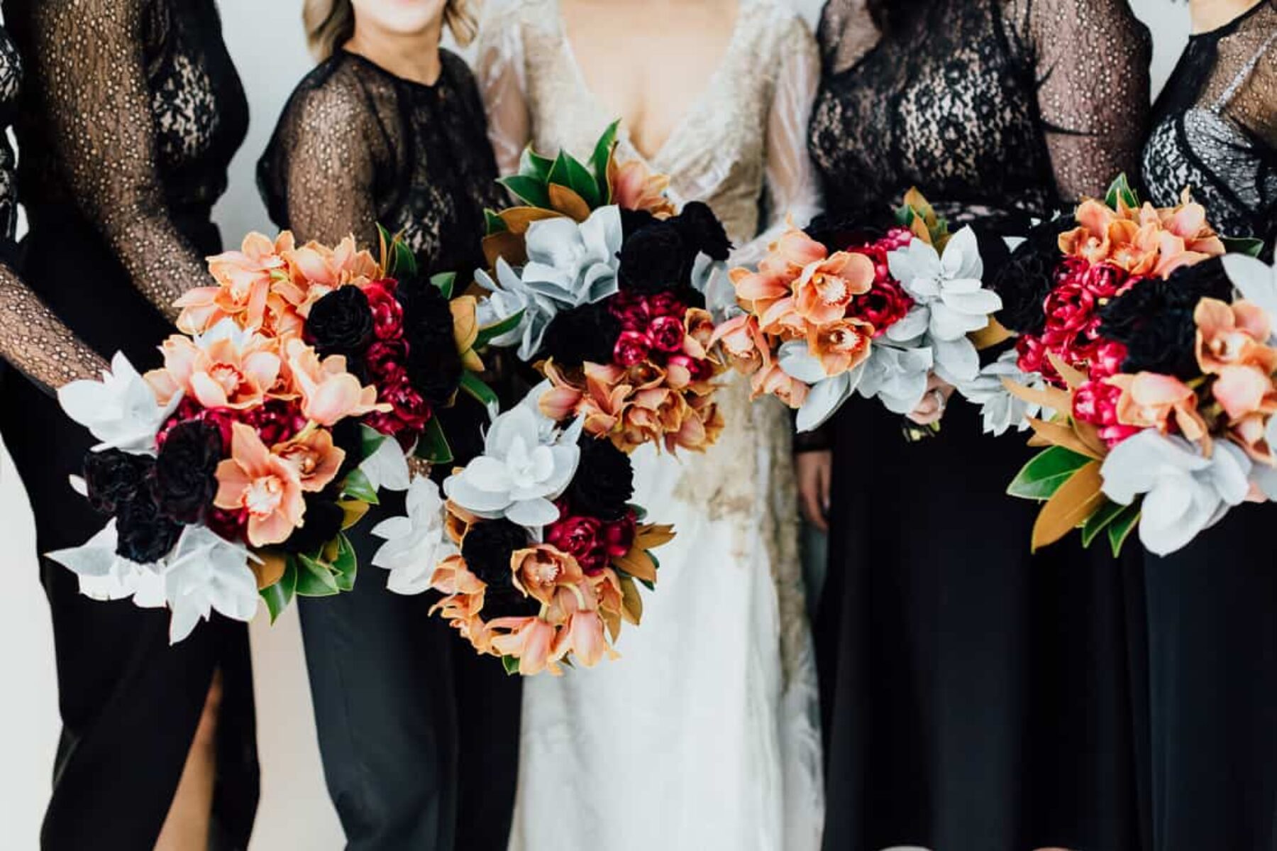 black lace bridesmaid dresses and copper-toned bouquet