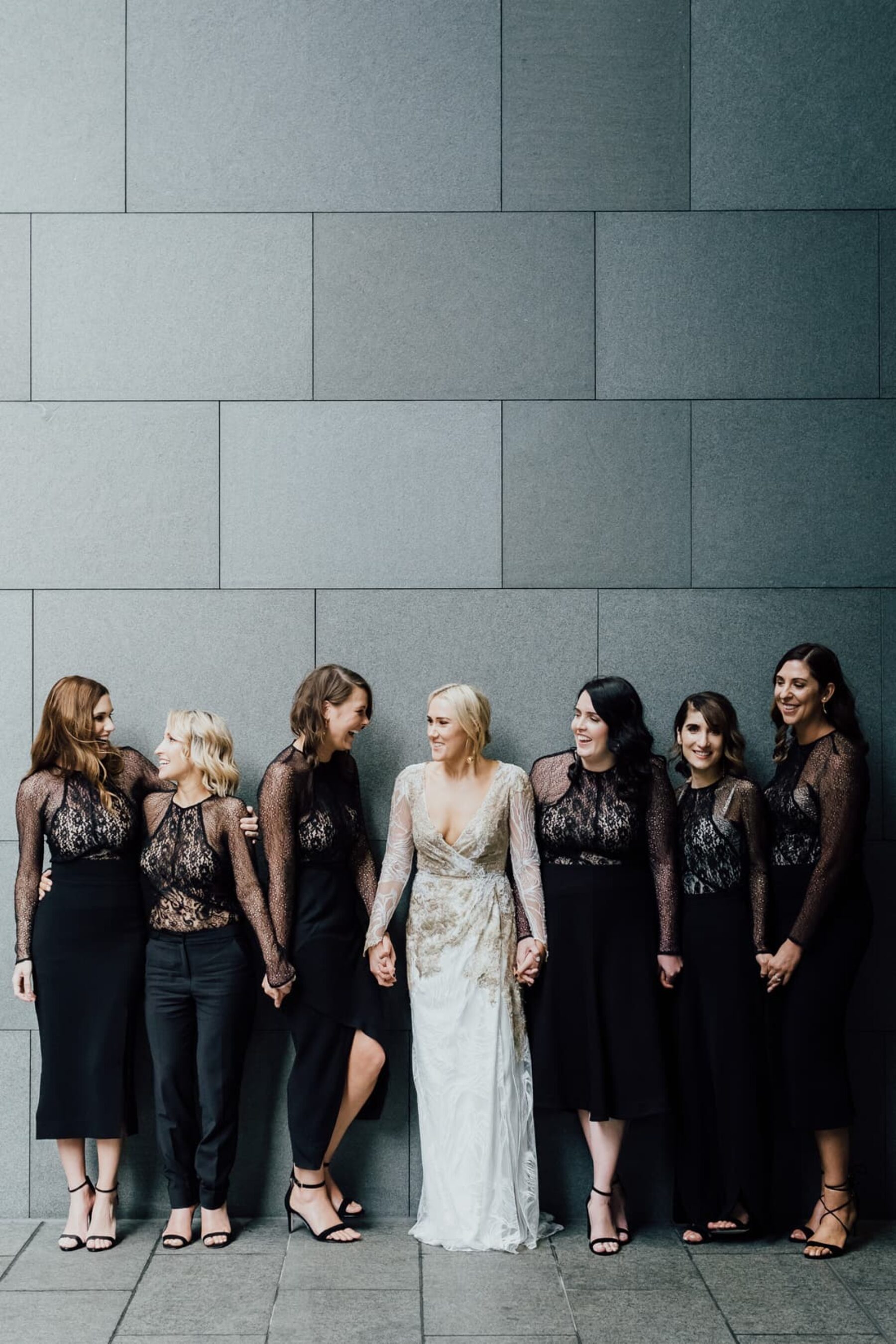 Modern bride and bridesmaids in lace black dresses