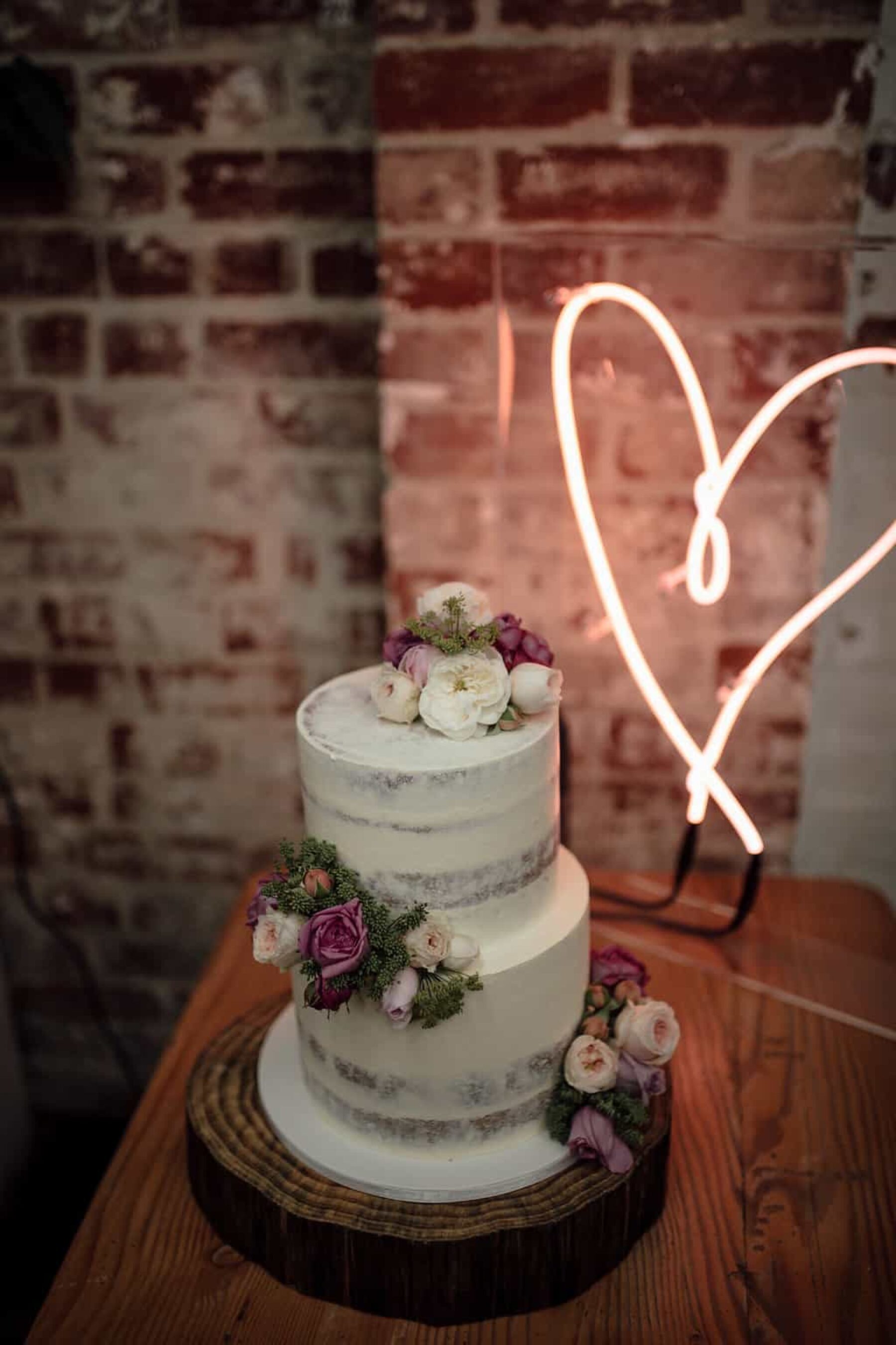 simple, modern wedding cake with fresh flowers