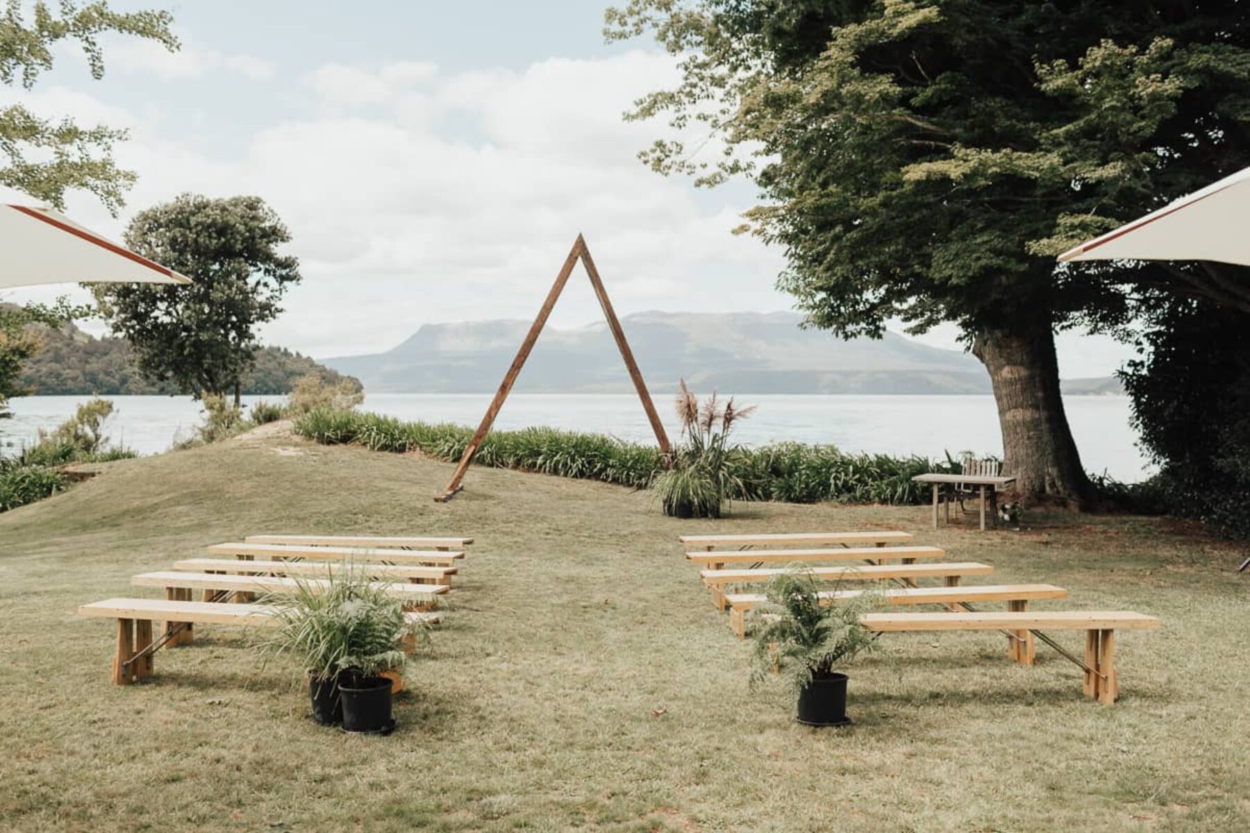 lakeside weddng with minimal triangle backdrop