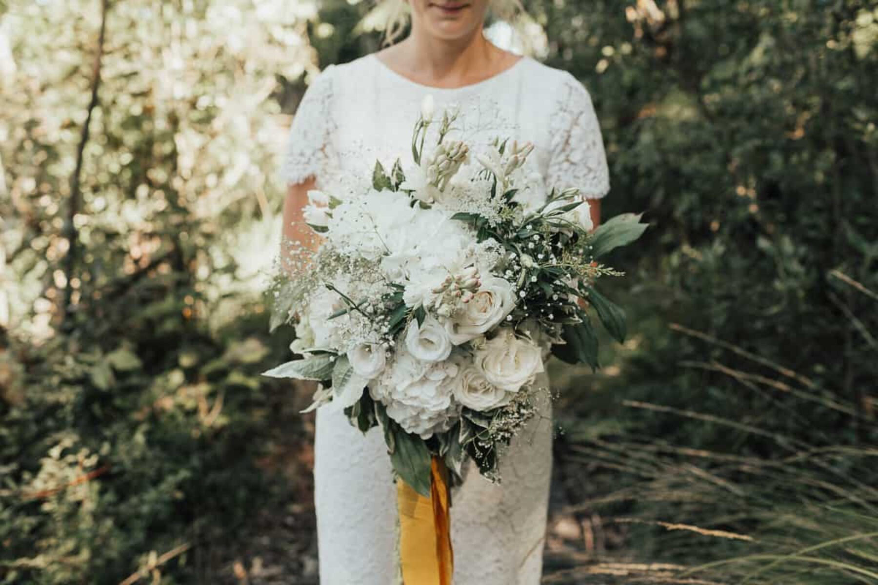 white bridal bouquet with yellow ribbon