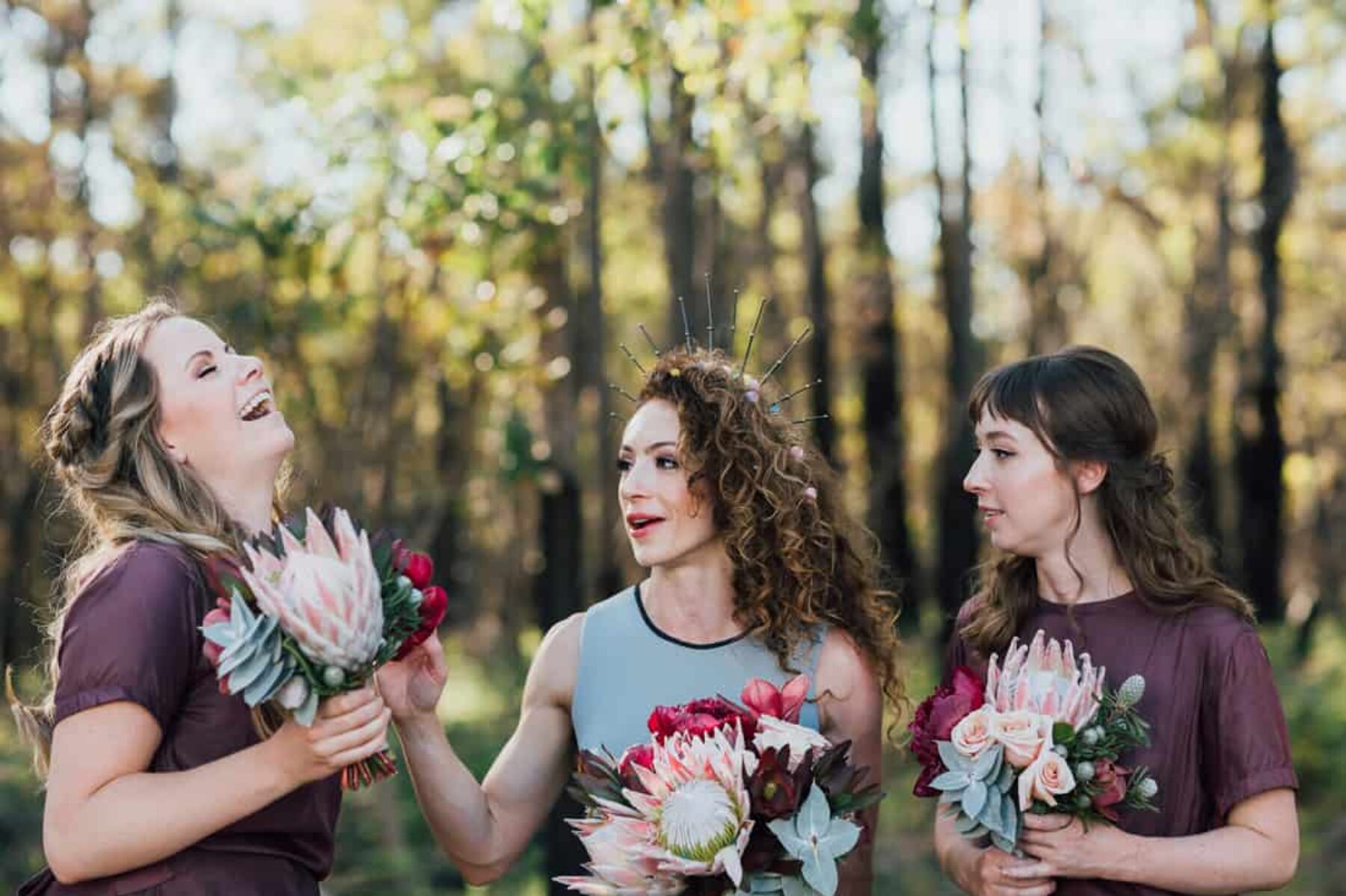 bride and bridesmaids with protea bouquets