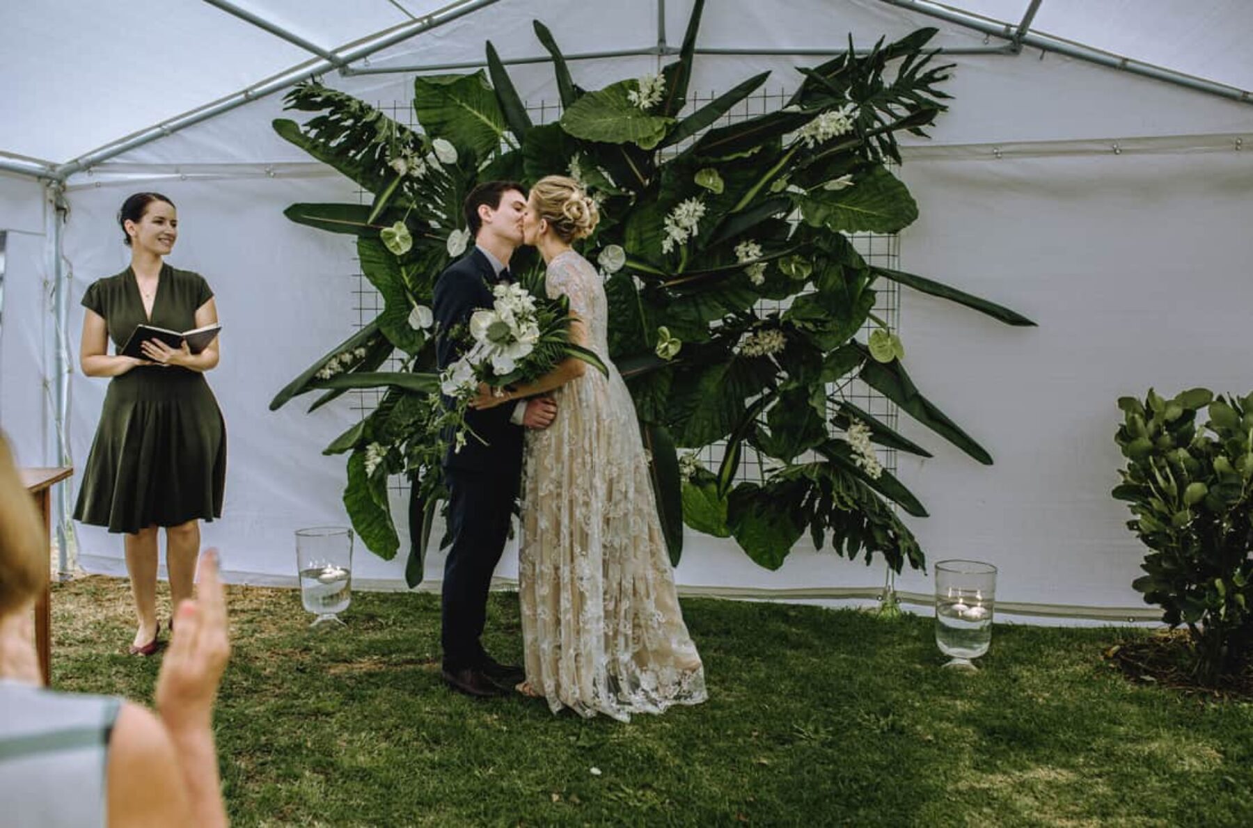 DIY greenery wedding backdrop with tropical oliage