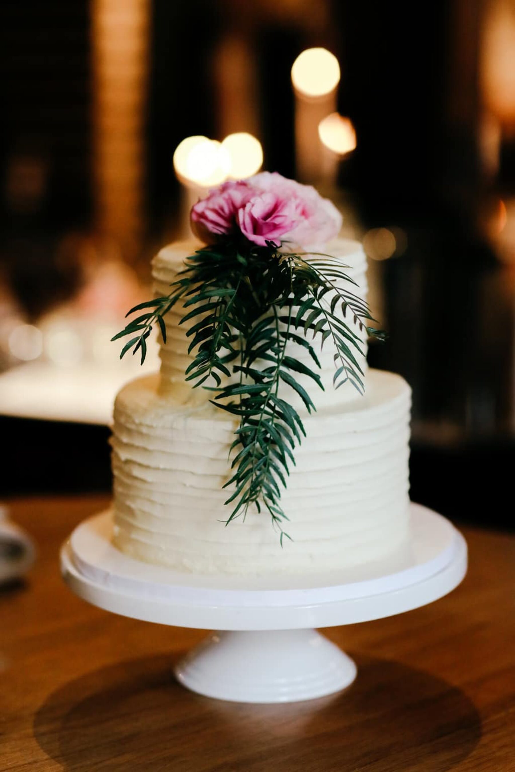 simple wedding cake with flower + foliage topper