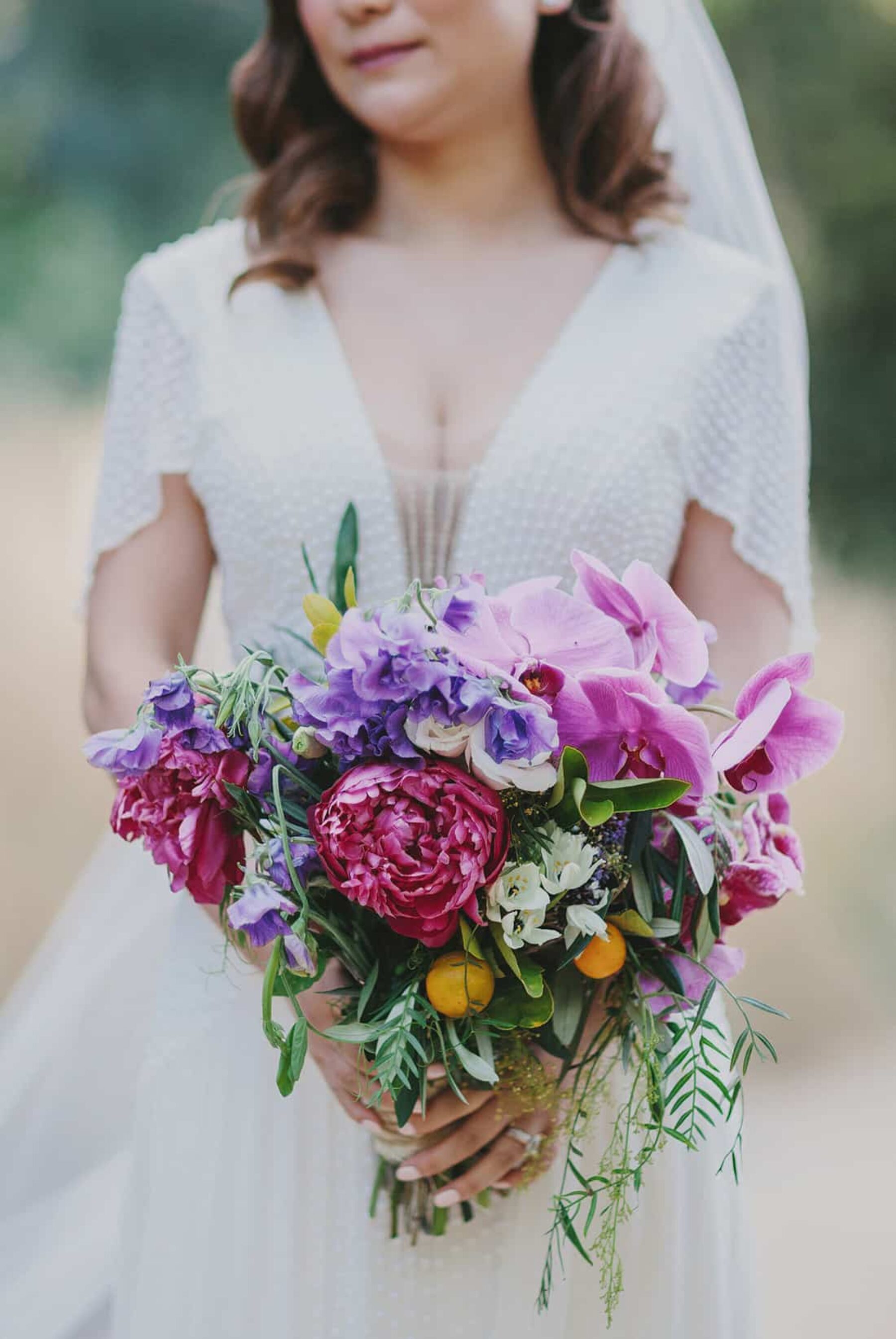 purple bridal bouquet with pink orchids