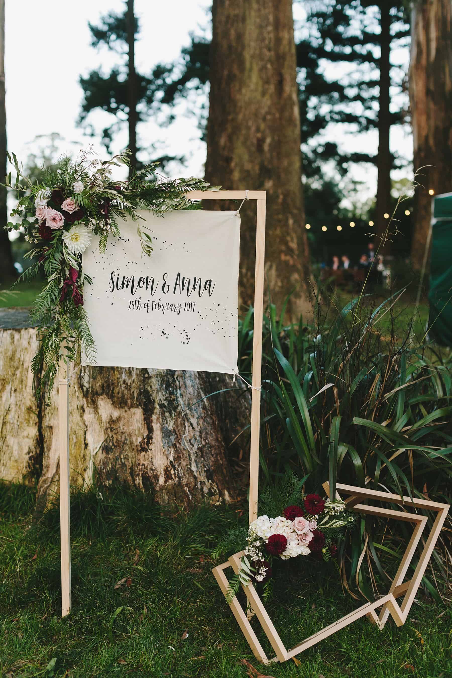 Fun floral wedding signage with timber arrow