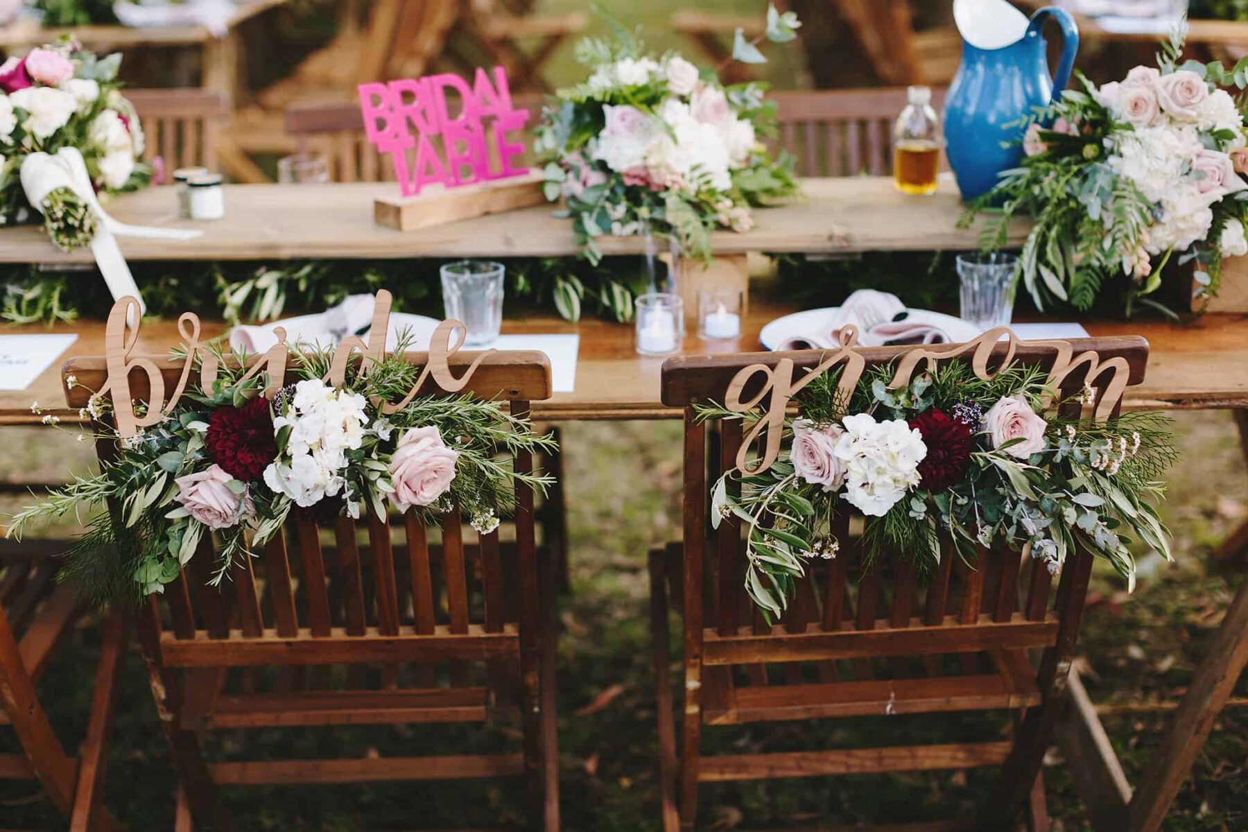fun bridal table with bride and groom chair signs