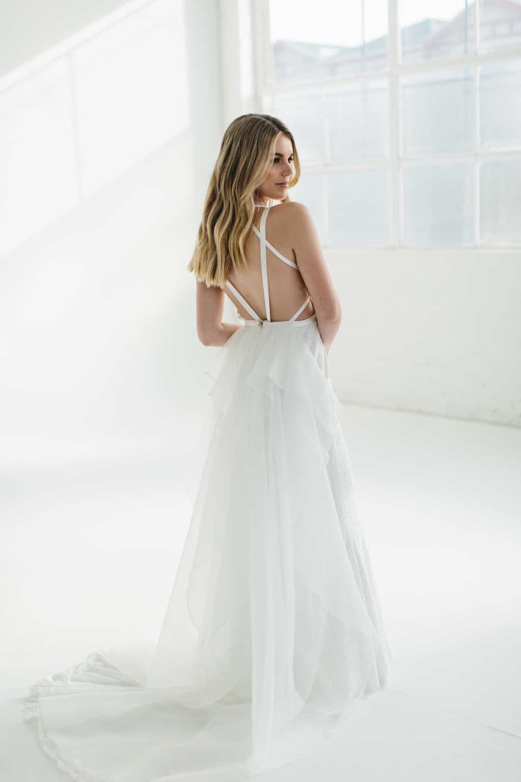 modern wedding dress with bustle and cross back detail