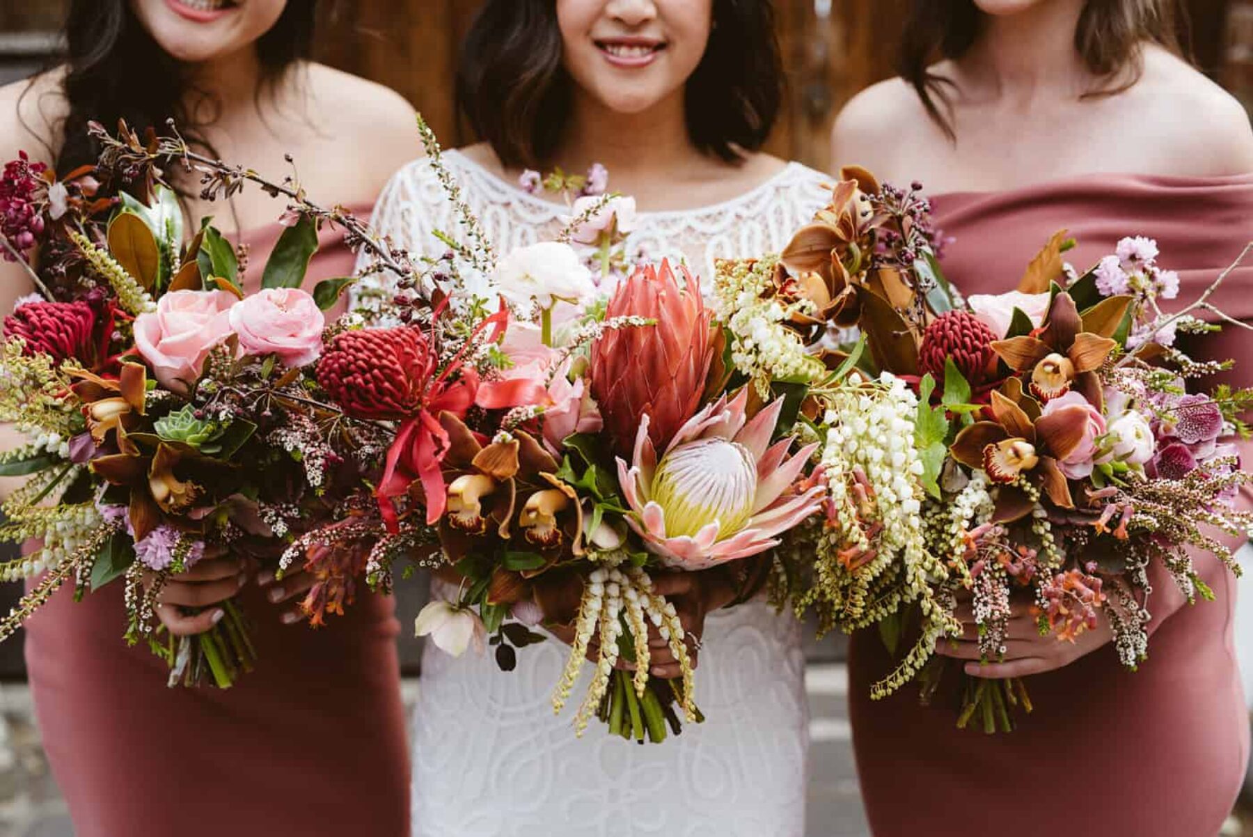 blush and dusty pink bouquets with king proteas and native flowers