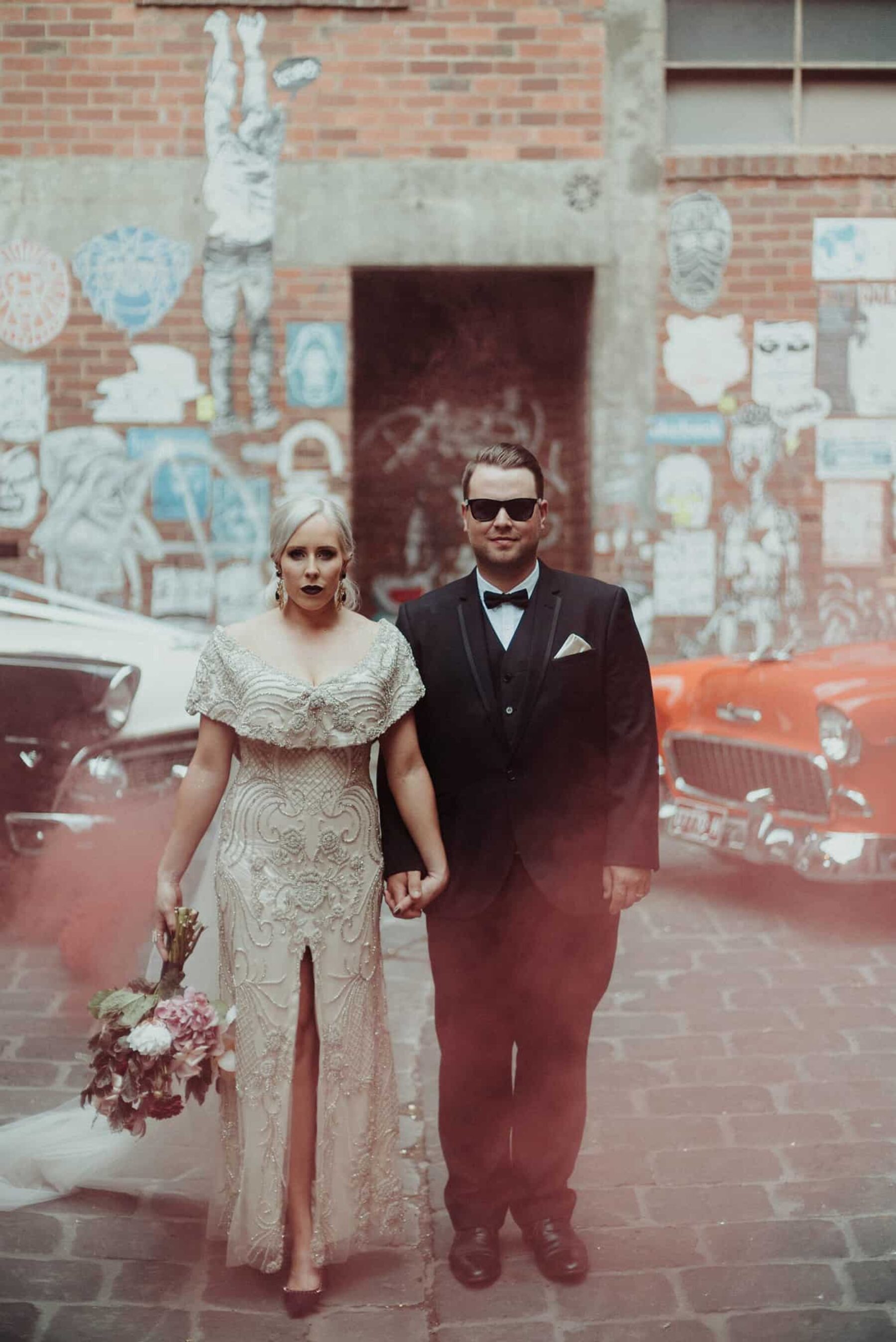 bride and groom with colour smoke bomb in Melbourne laneways