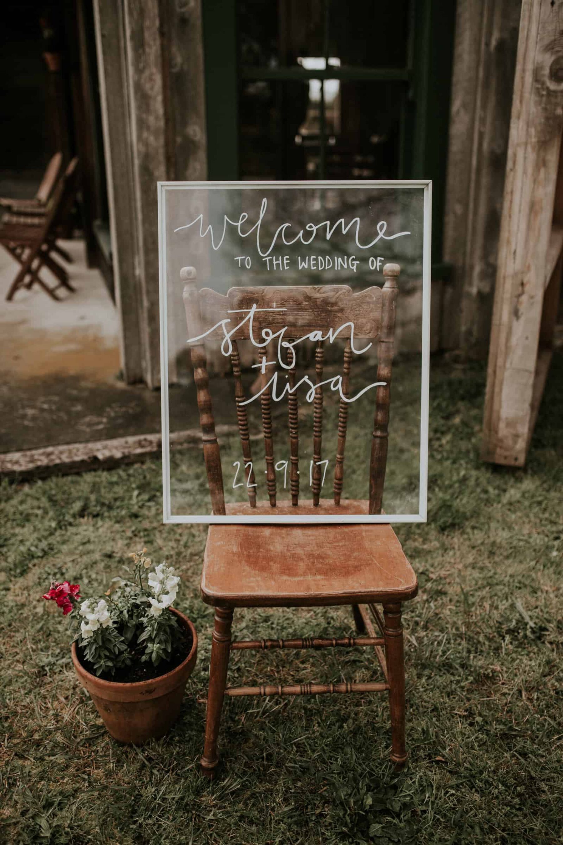 hand lettered glass wedding welcome board