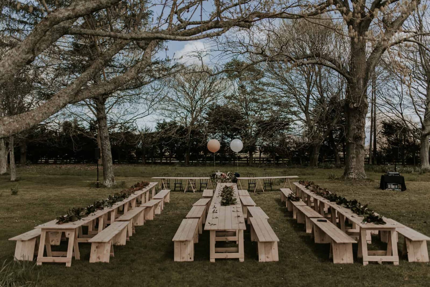 timber trestle tables for an outdoor wedding feast