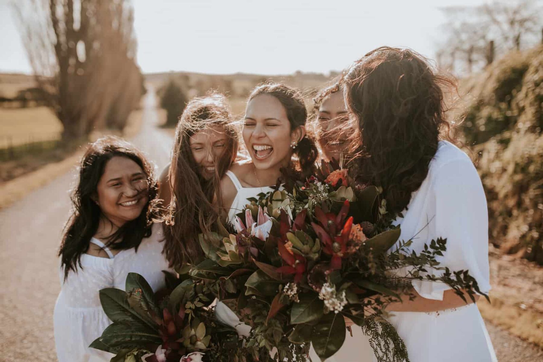 bridesmaids in mixed white dresses