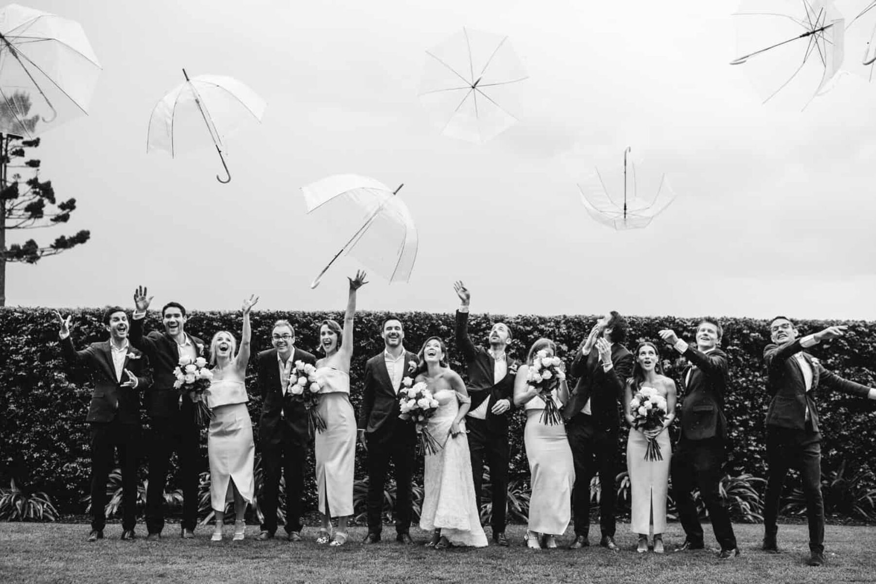 bridal party with clear umbrellas