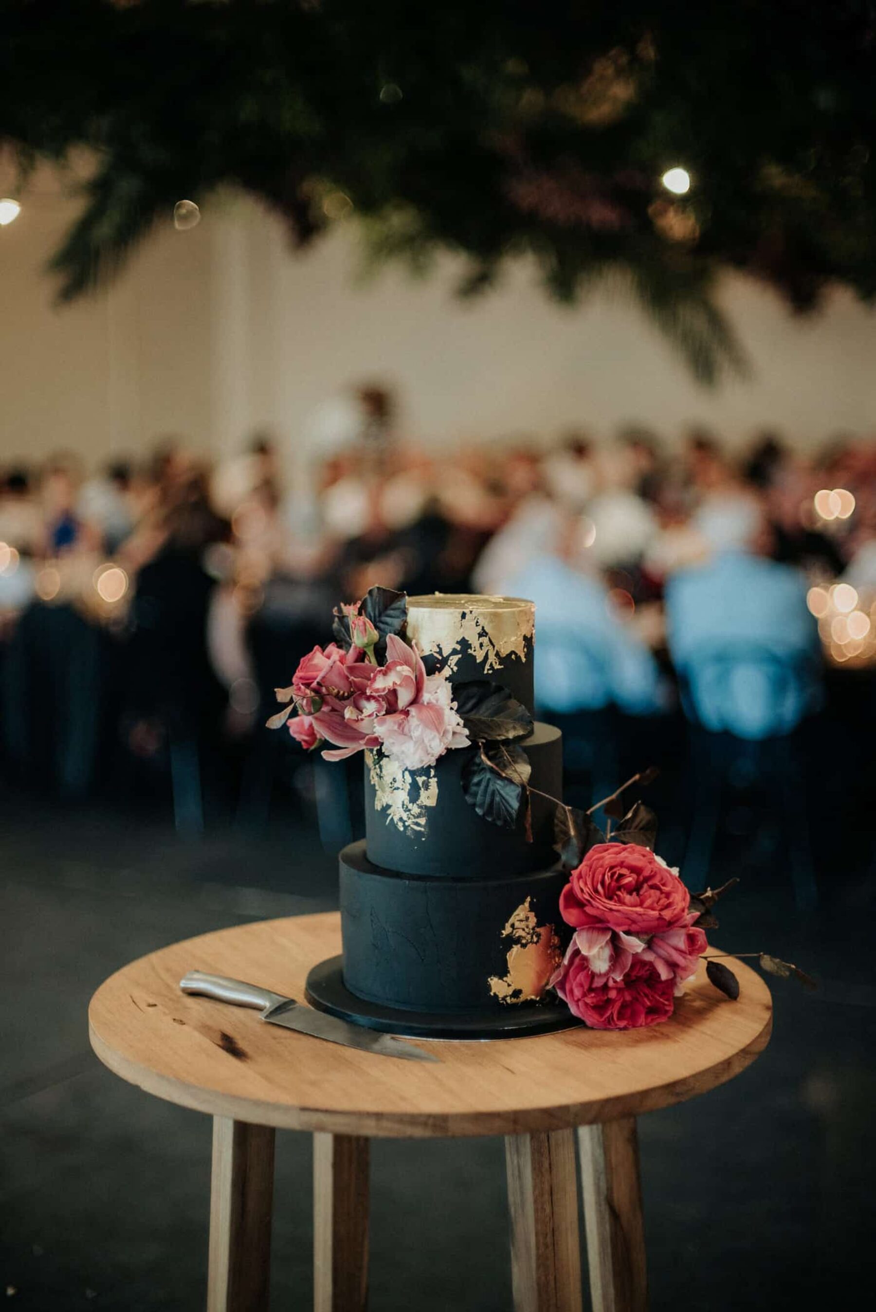 3 tier black wedding cake with gold leaf