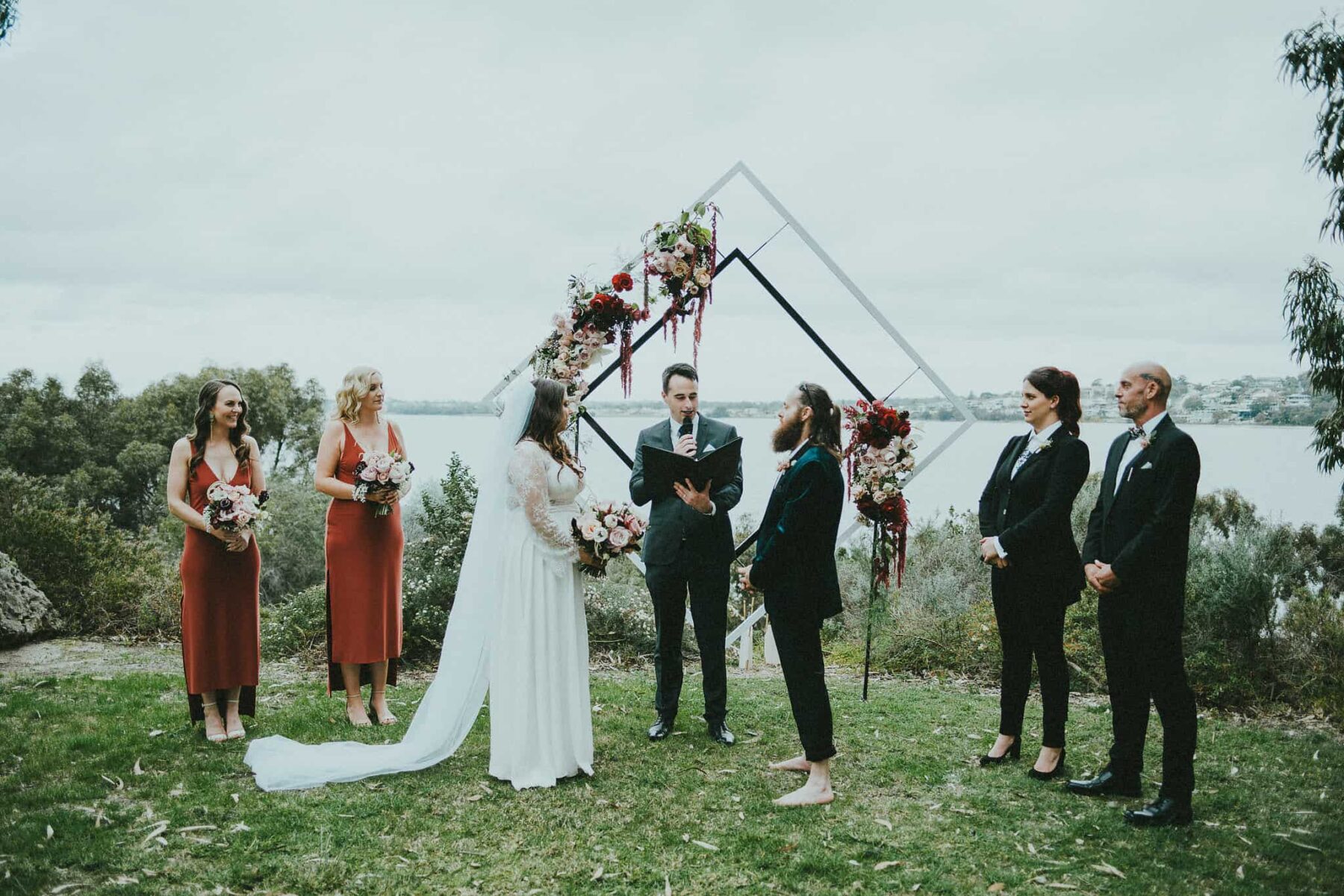 modern diamond wedding arbour with blush and burgundy flowers