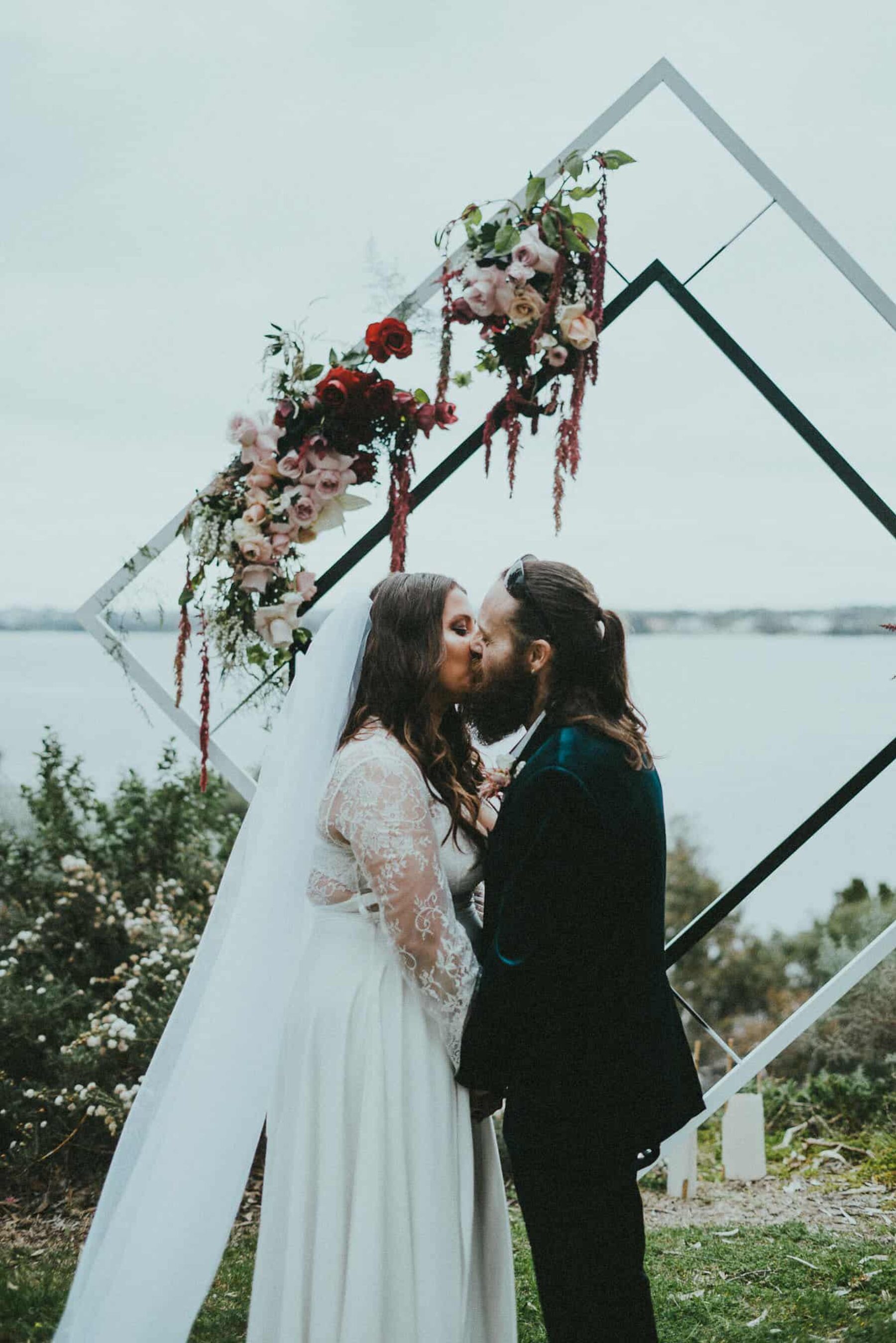 modern diamond wedding arbour with blush and burgundy flowers