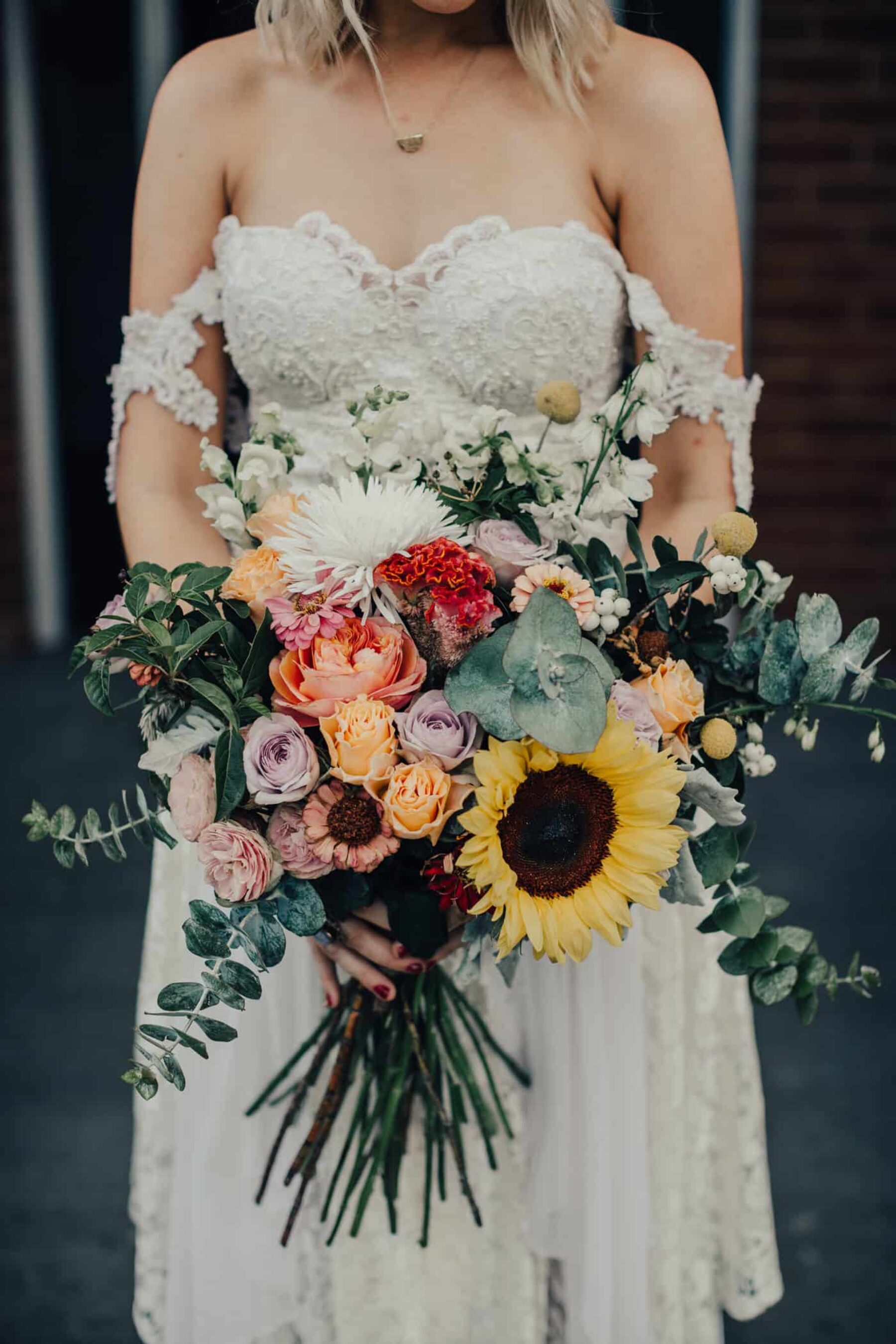 Boho bride with sunflower bouquet